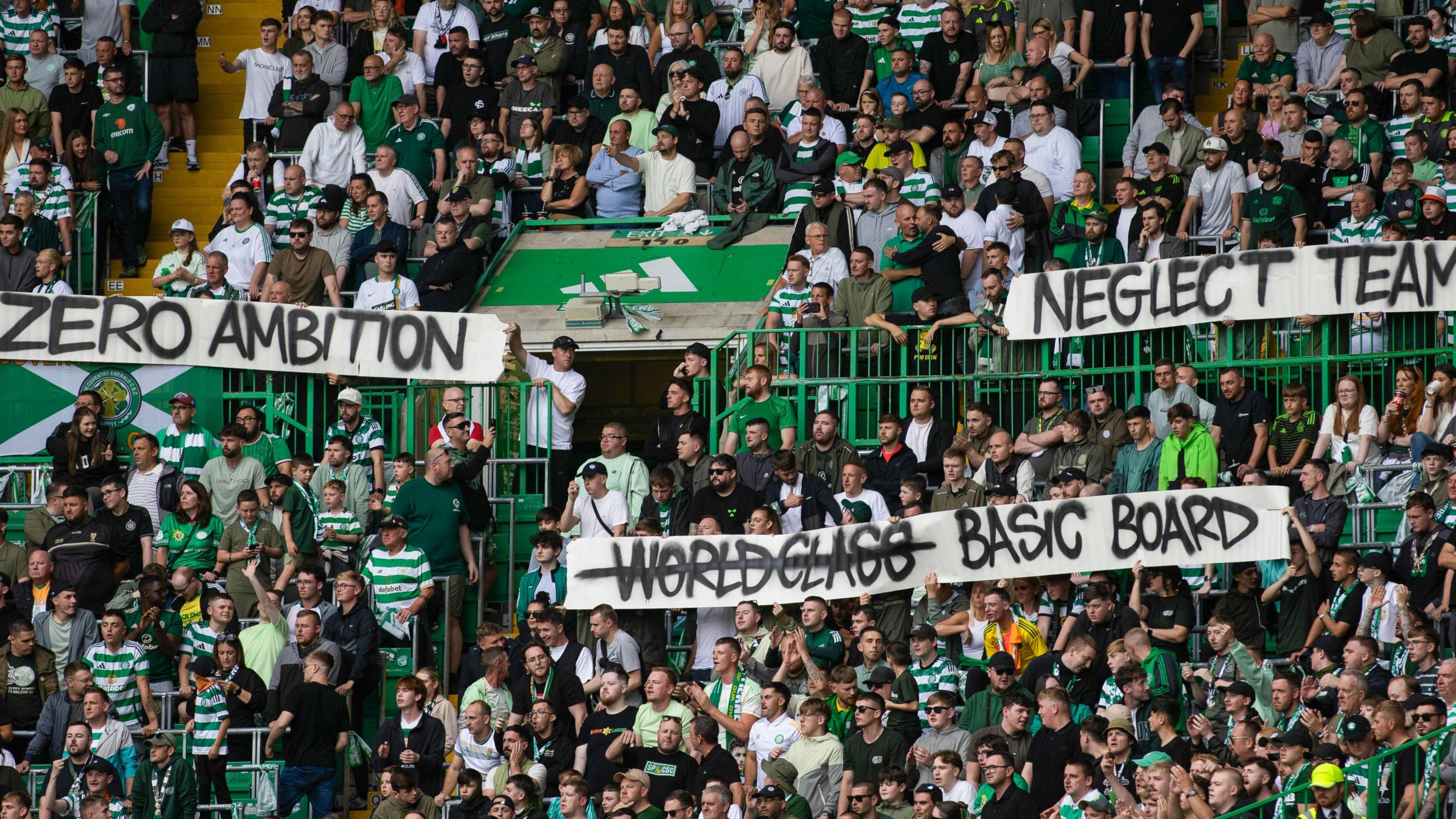 Celtic fans hold banners reading "Zero Ambition", "Neglect Team" and "Basic Board" during a William Hill Premiership match between Celtic and Livingston at Celtic Park