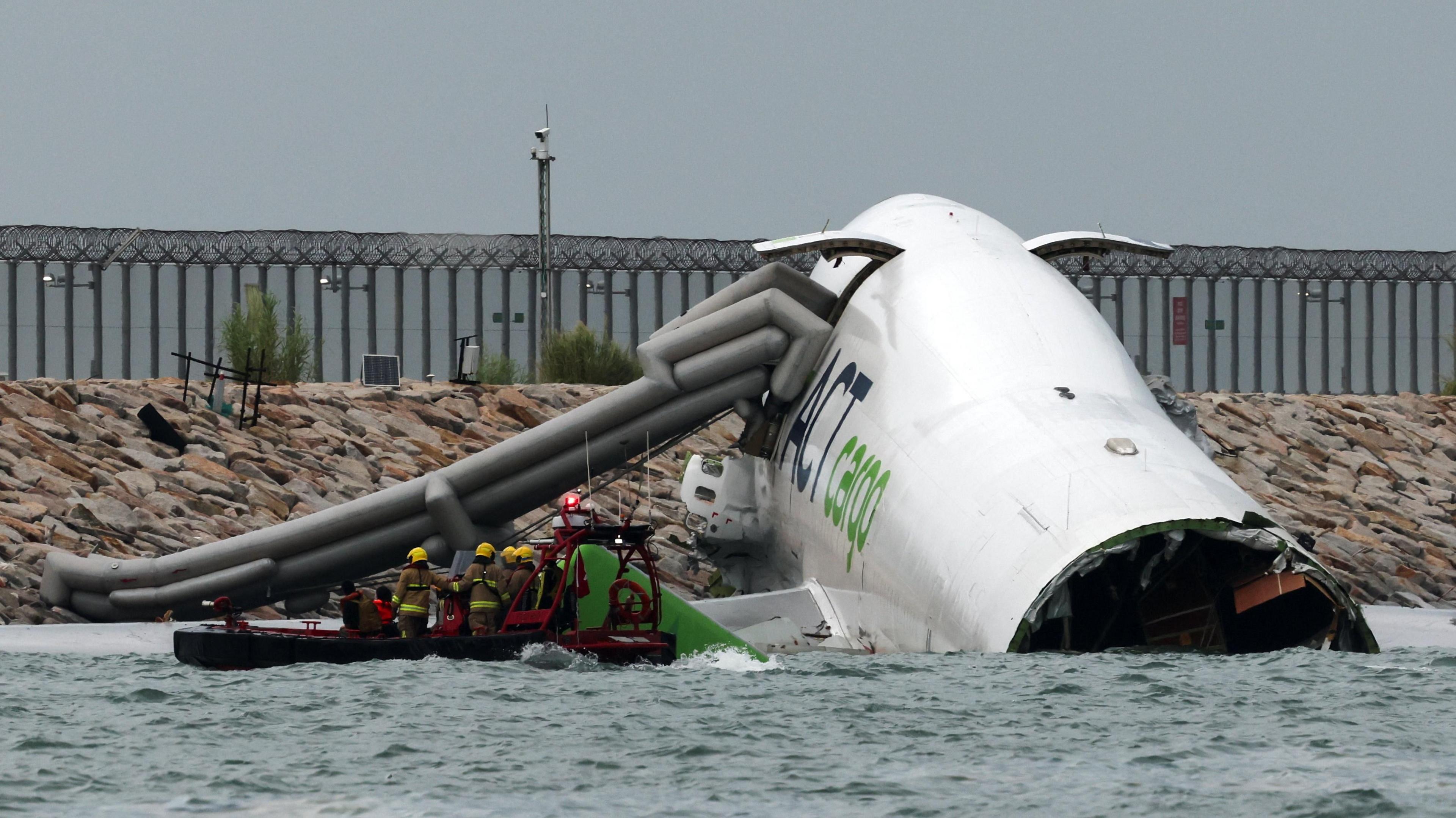 Part of the plane's fuselage is lying in the water off the runway