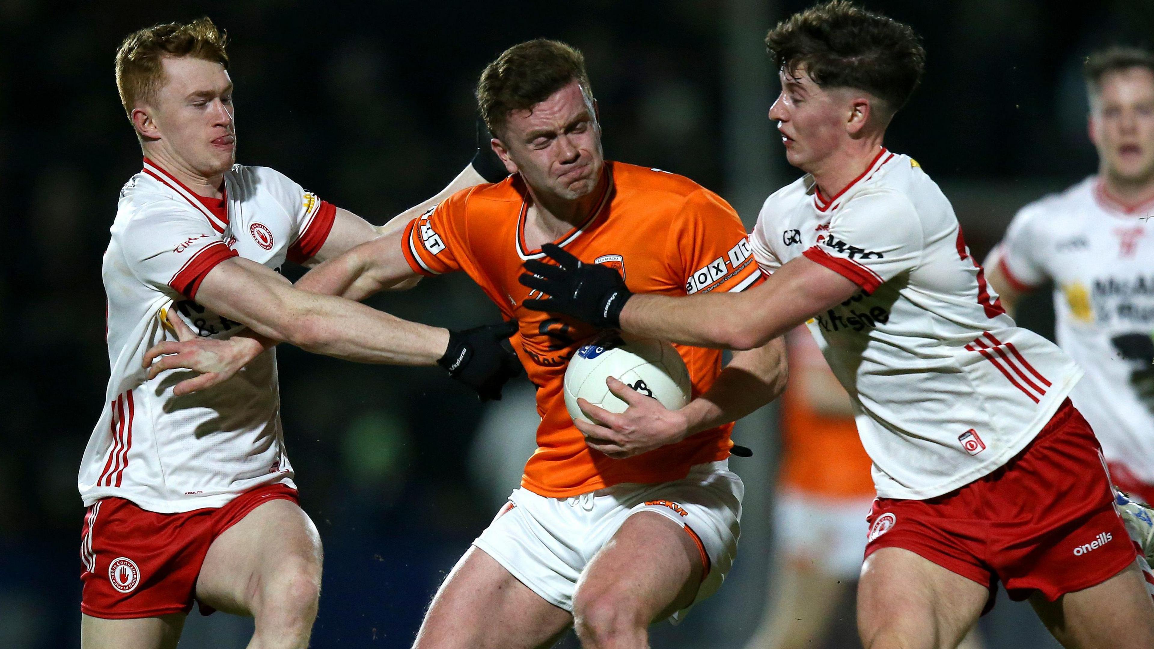 Tyrone players try to shackle Ross McQuillan, who was one of Armagh's two-point scorers in the Athletic Grounds