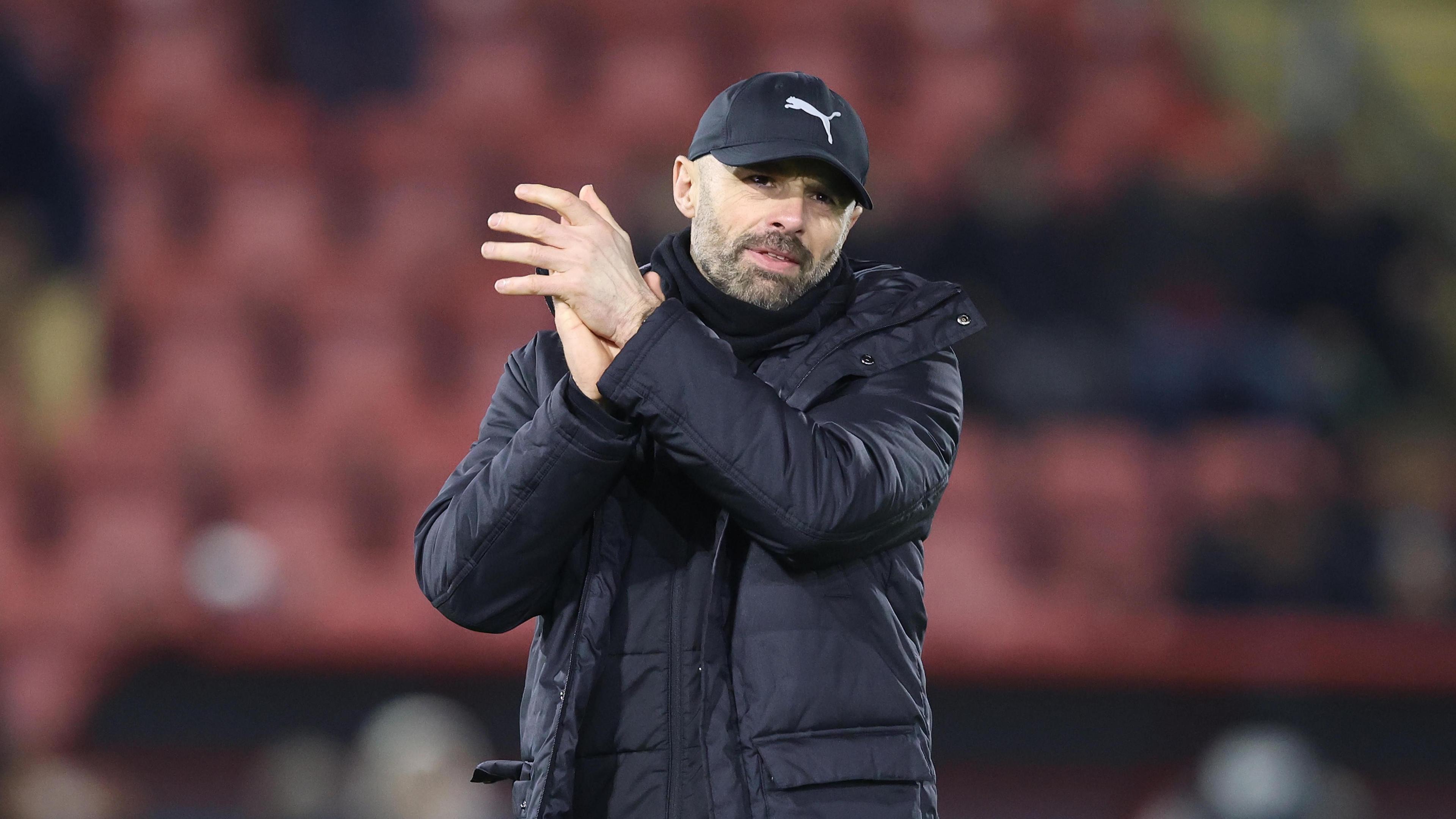 Derby County boss Paul Warne applauding the fans