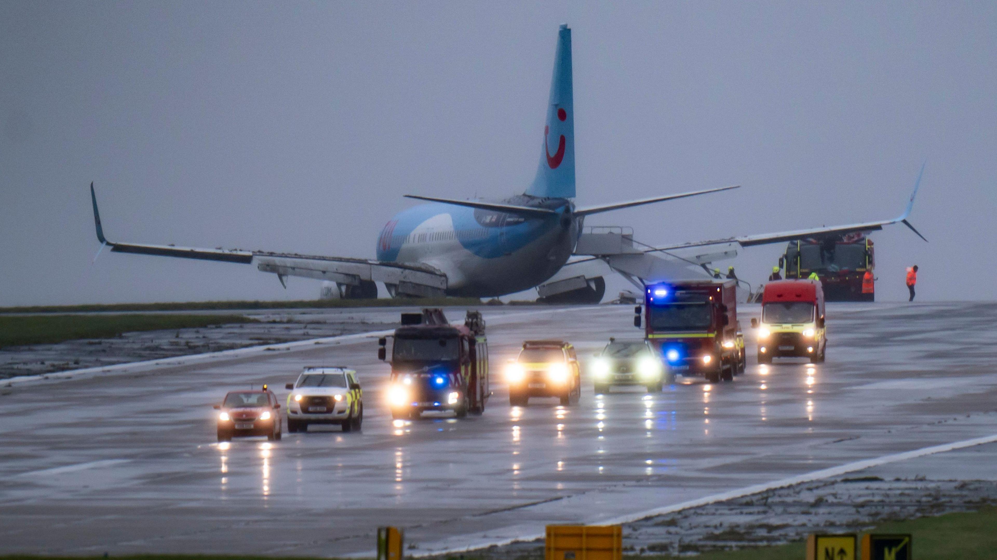 Emergency services on the runway at Leeds Bradford Airport with a TUI jet on the grass verge 