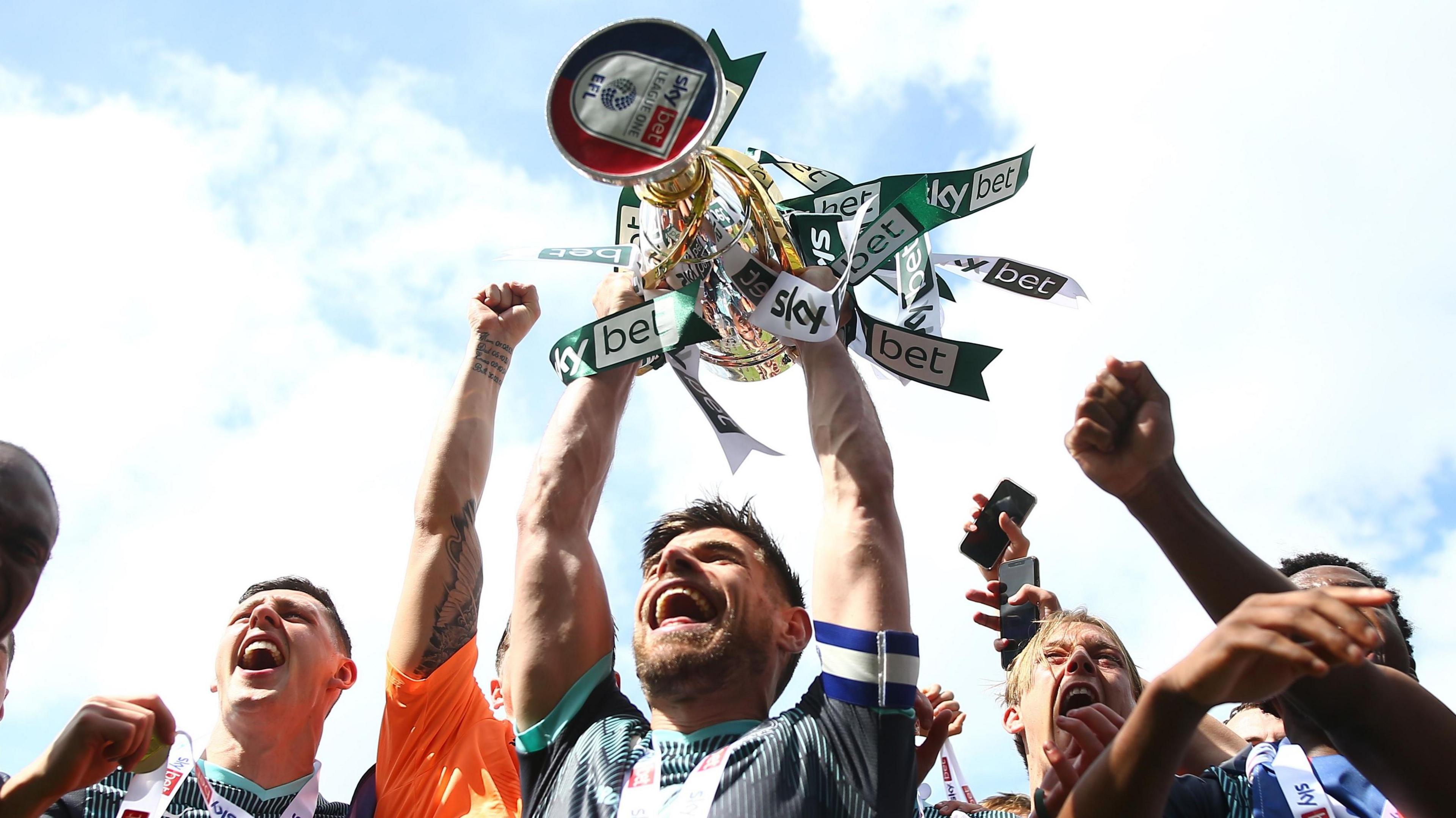 Joe Edwards lifts the League One title in 2023