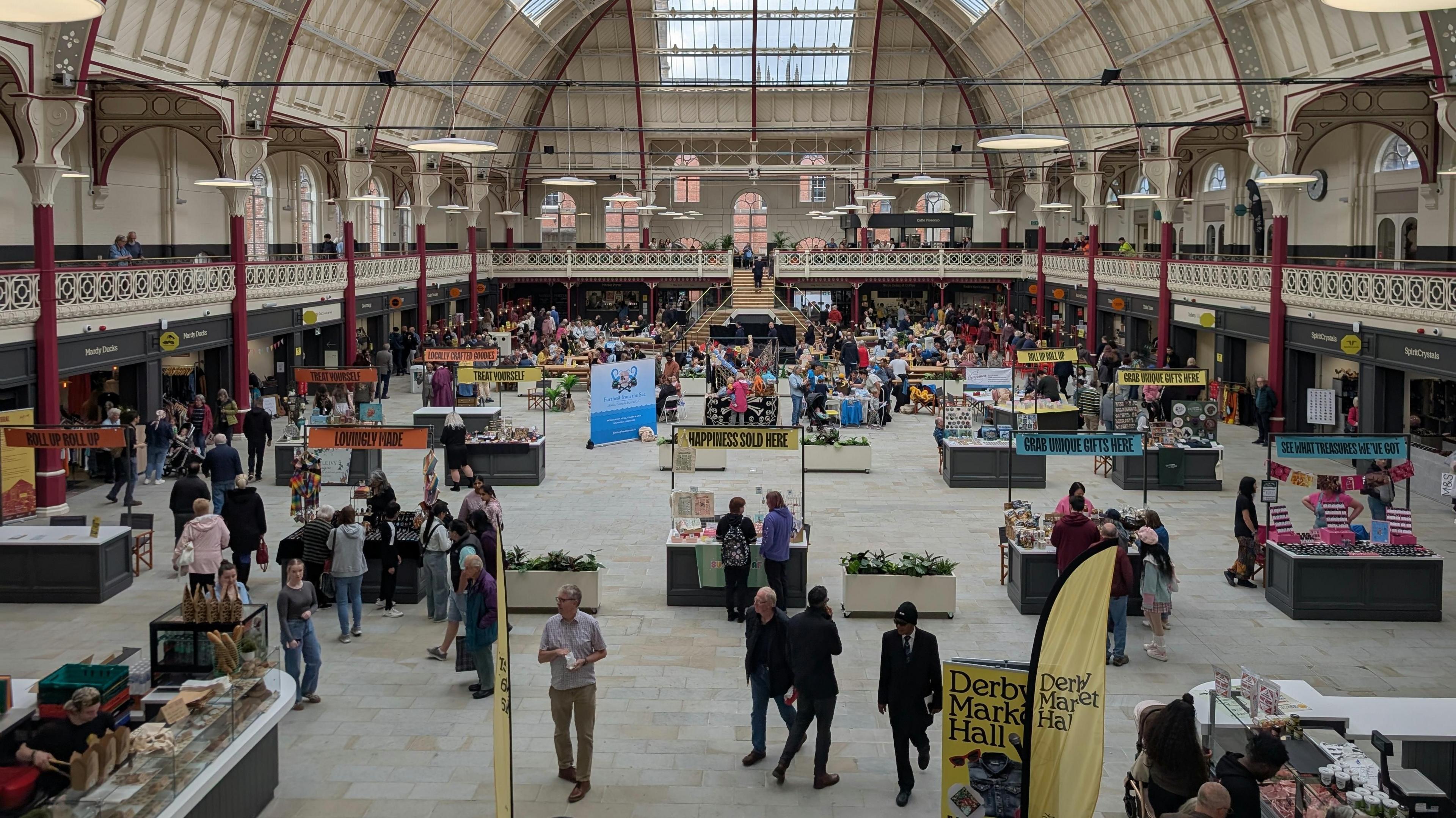 Above shot of the Market Hall in Derby showing people visiting the stalls when it first reopened.
