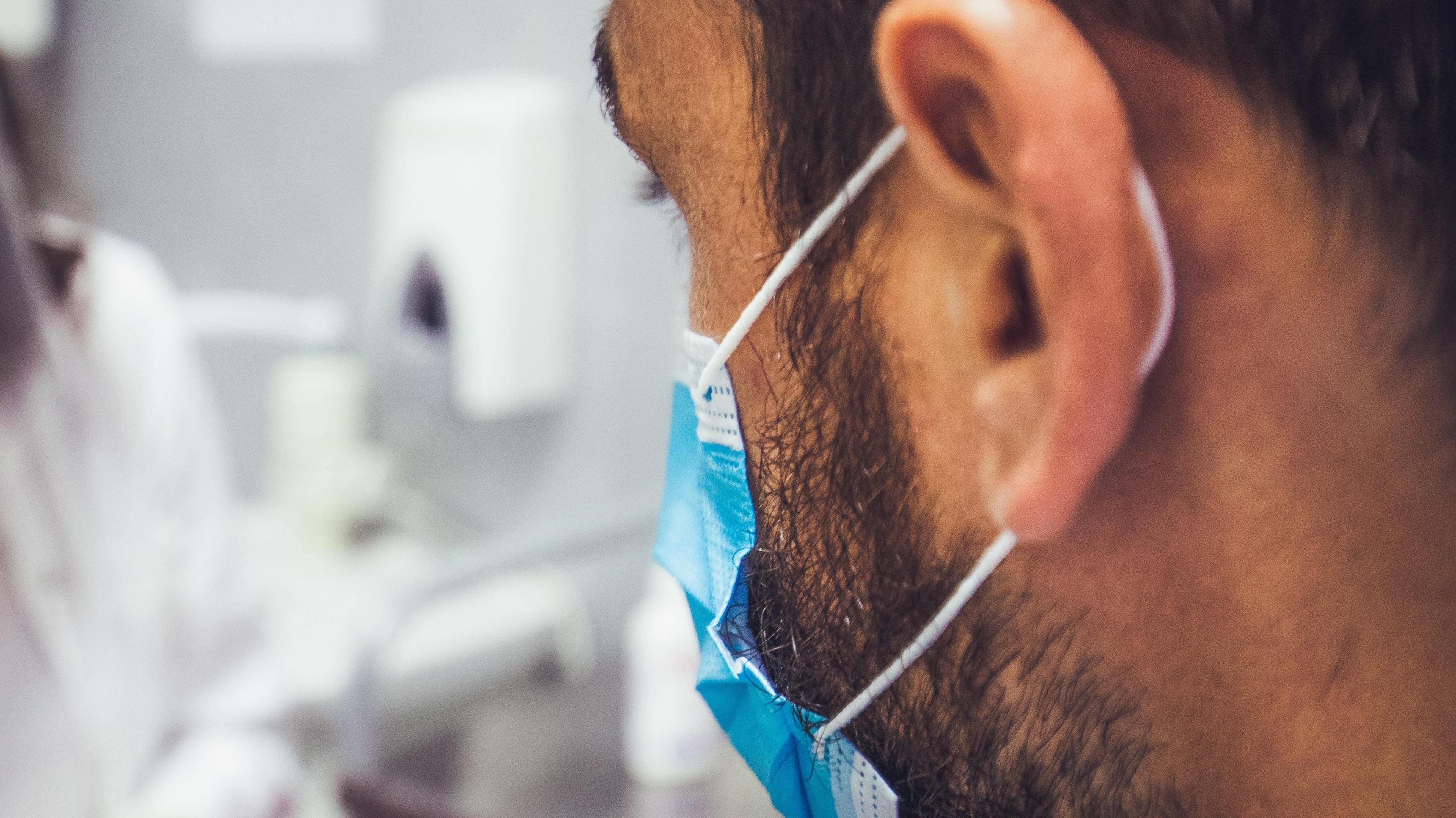 A man wearing a face mask in a hospital