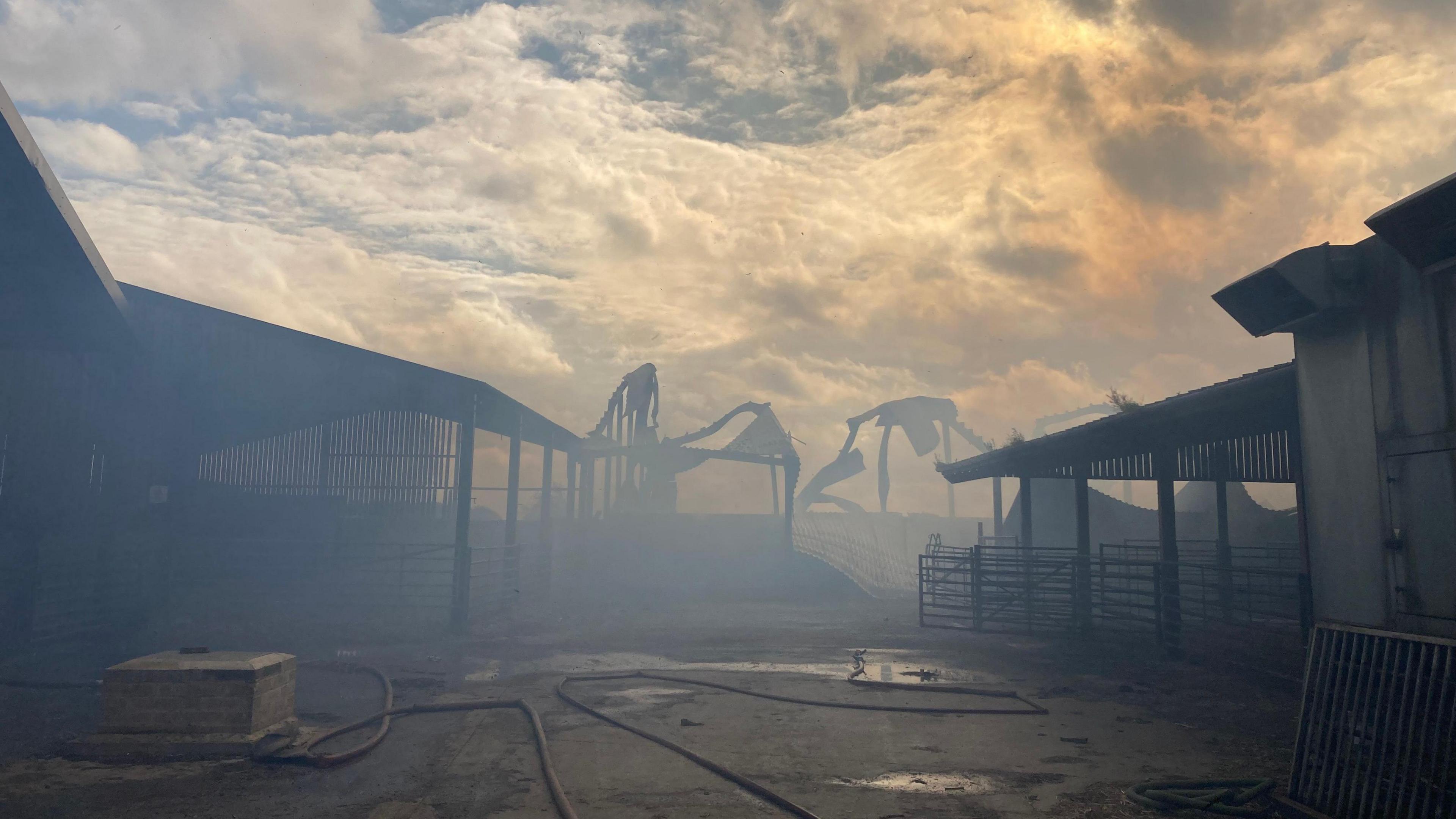 Smoke covering the rest of the farm, with the frame of the barn visible in the background.
