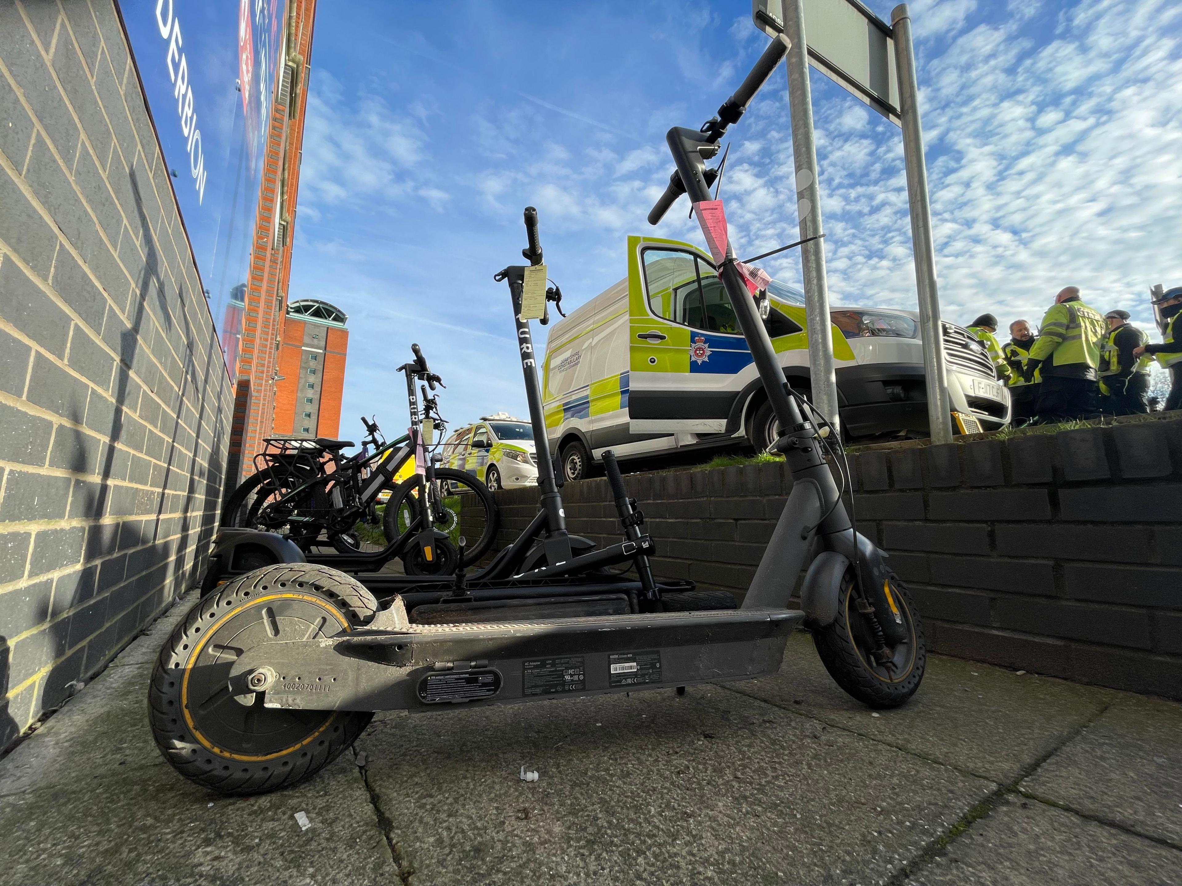 E-bikes and scooters parked near police officers