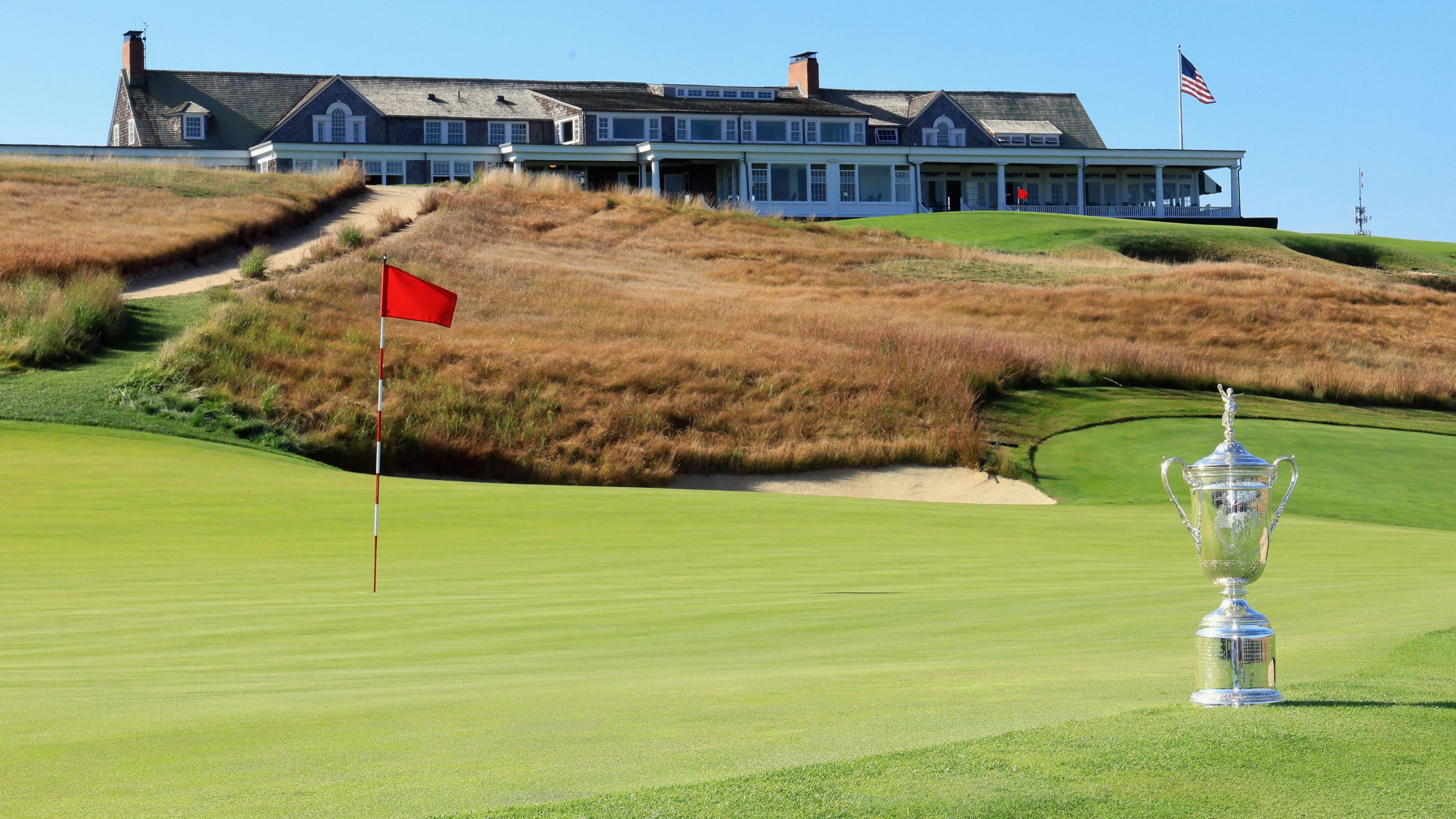 The US Open trophy is positioned on one of the greens at Shinnecock Hills