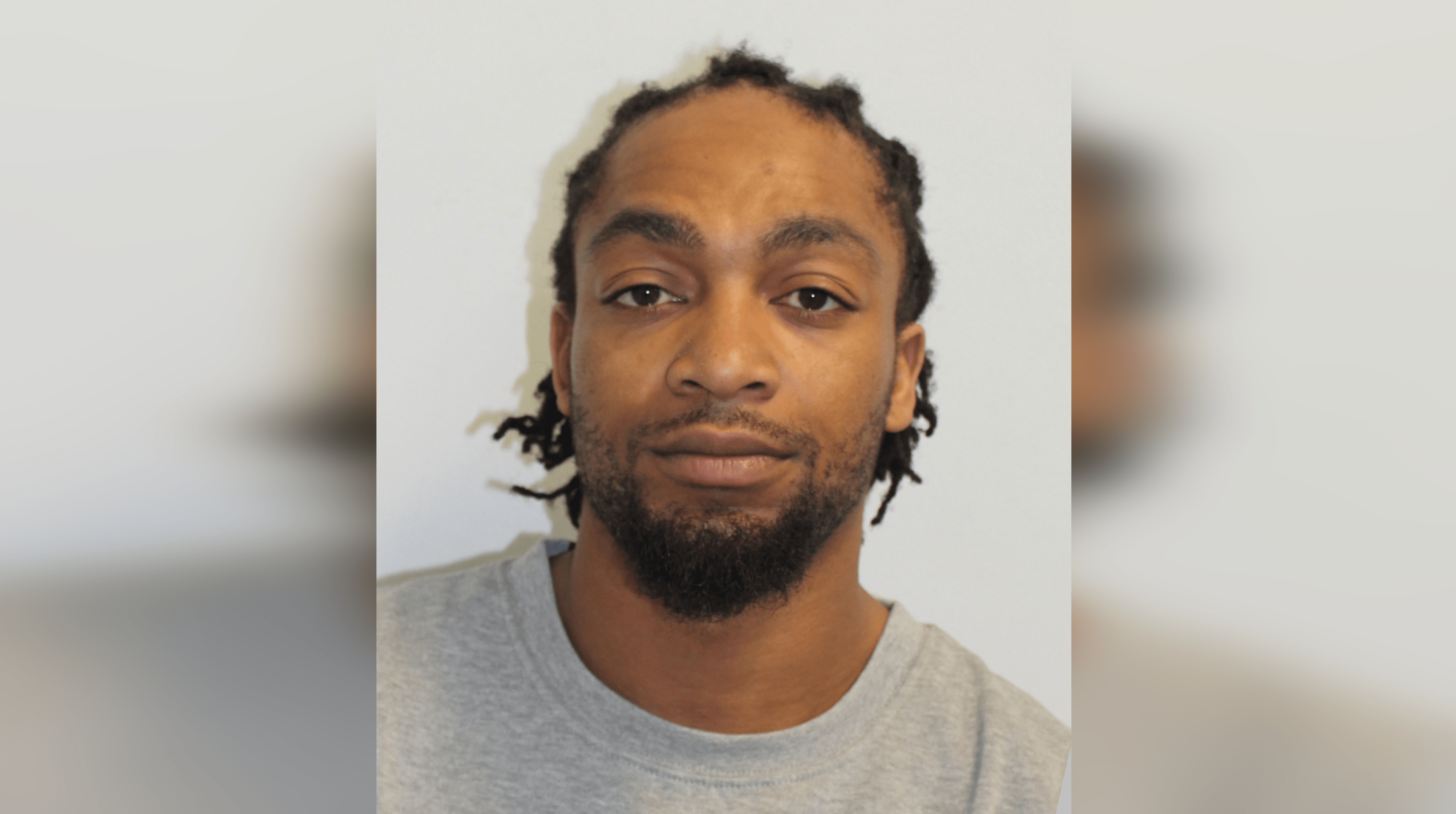 A Met Police custody image of Omar Wilson wearing  grey t-shirt.