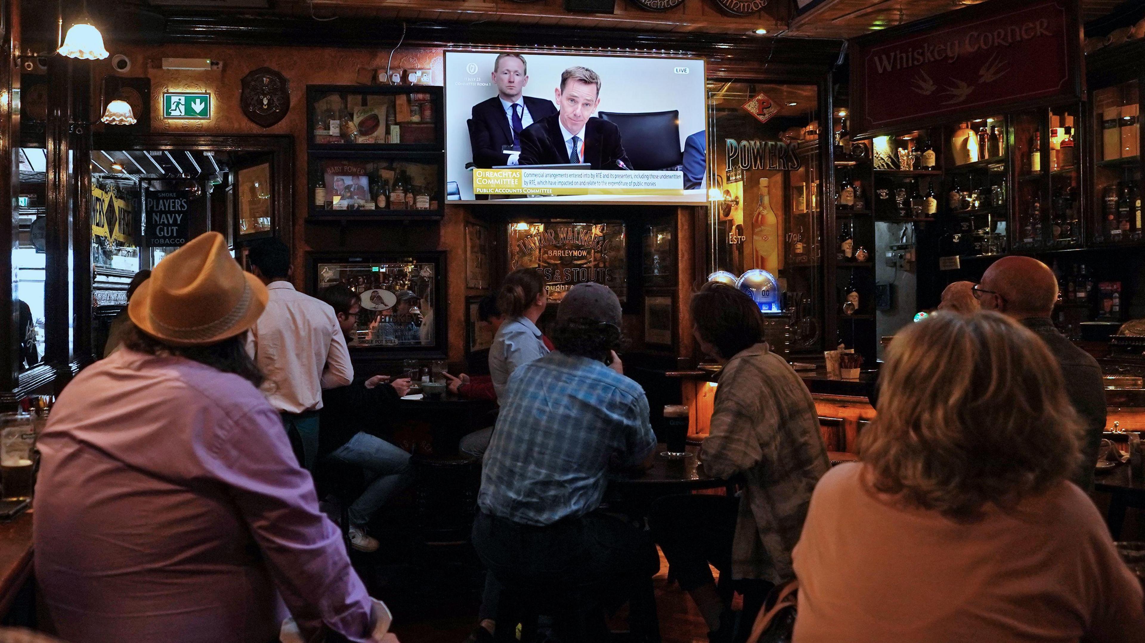 People in pub watch