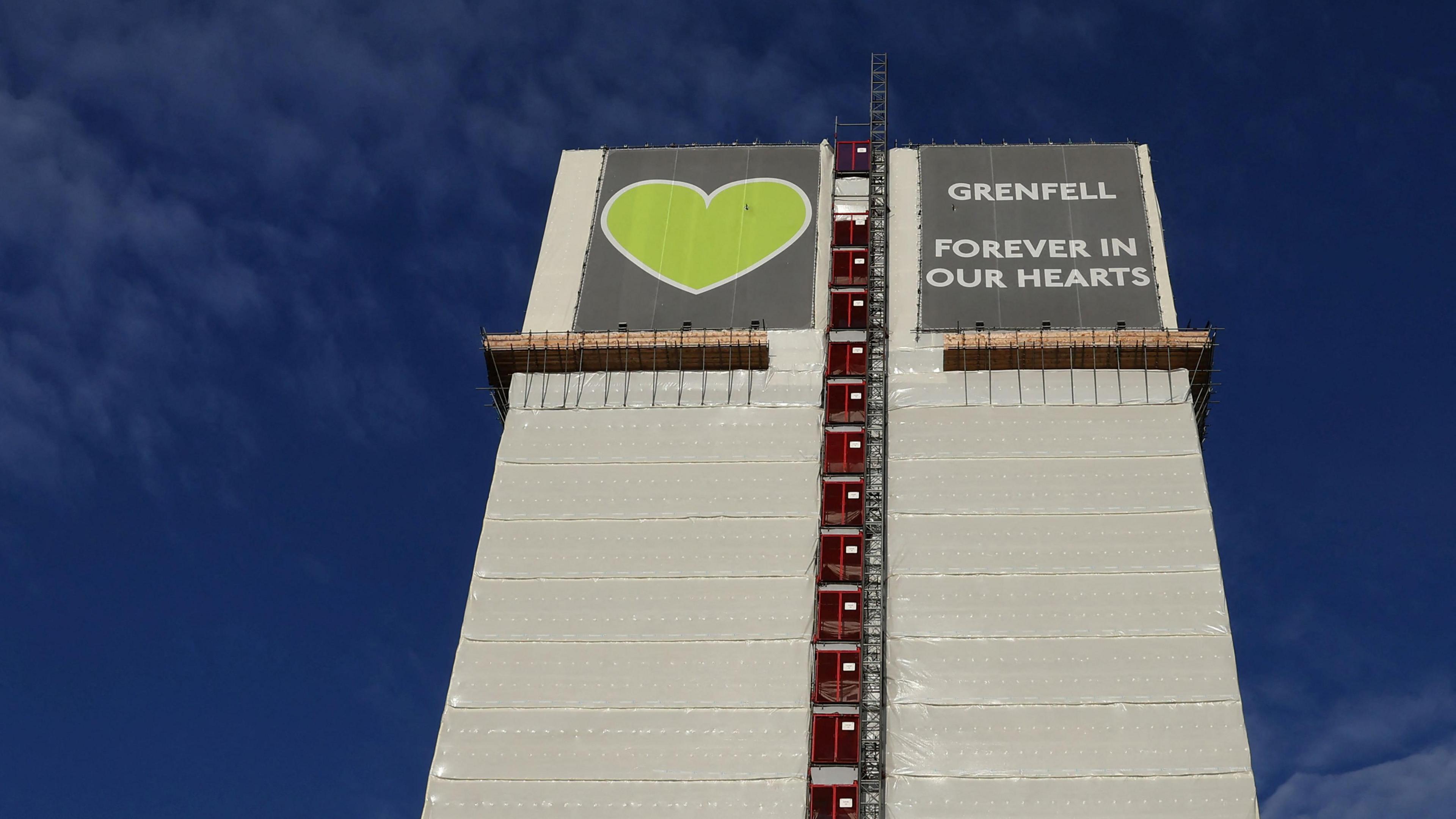 The covered remains of Grenfell Tower 