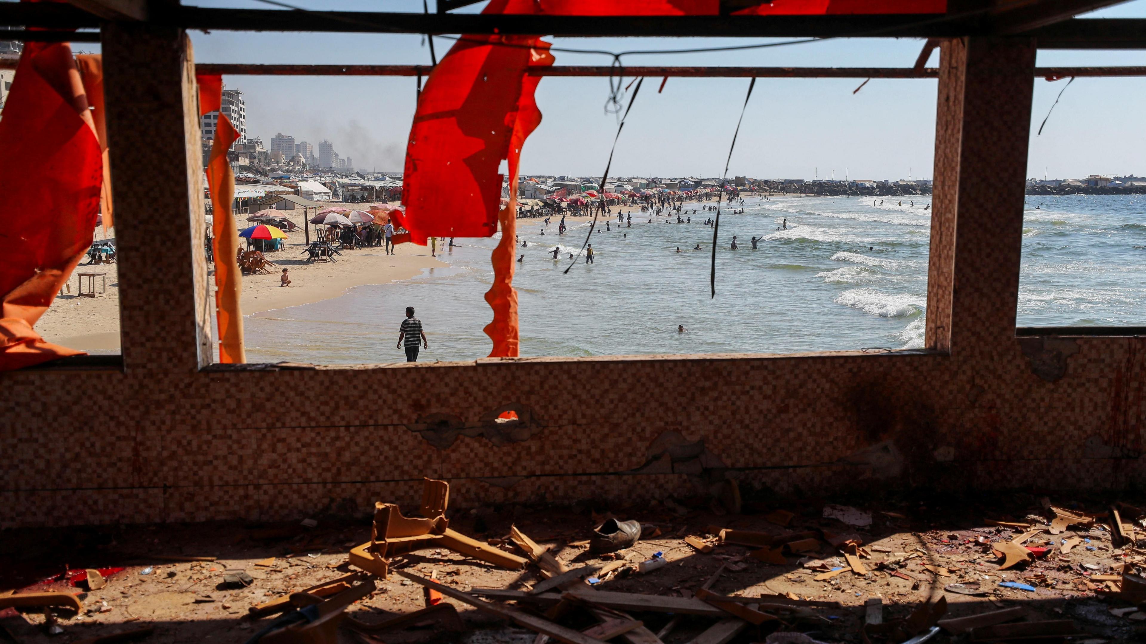A general view of a site following an Israeli airstrike on Al-Baqa cafeteria. Gaping windows and ripped, red awning can be seen in the foreground.