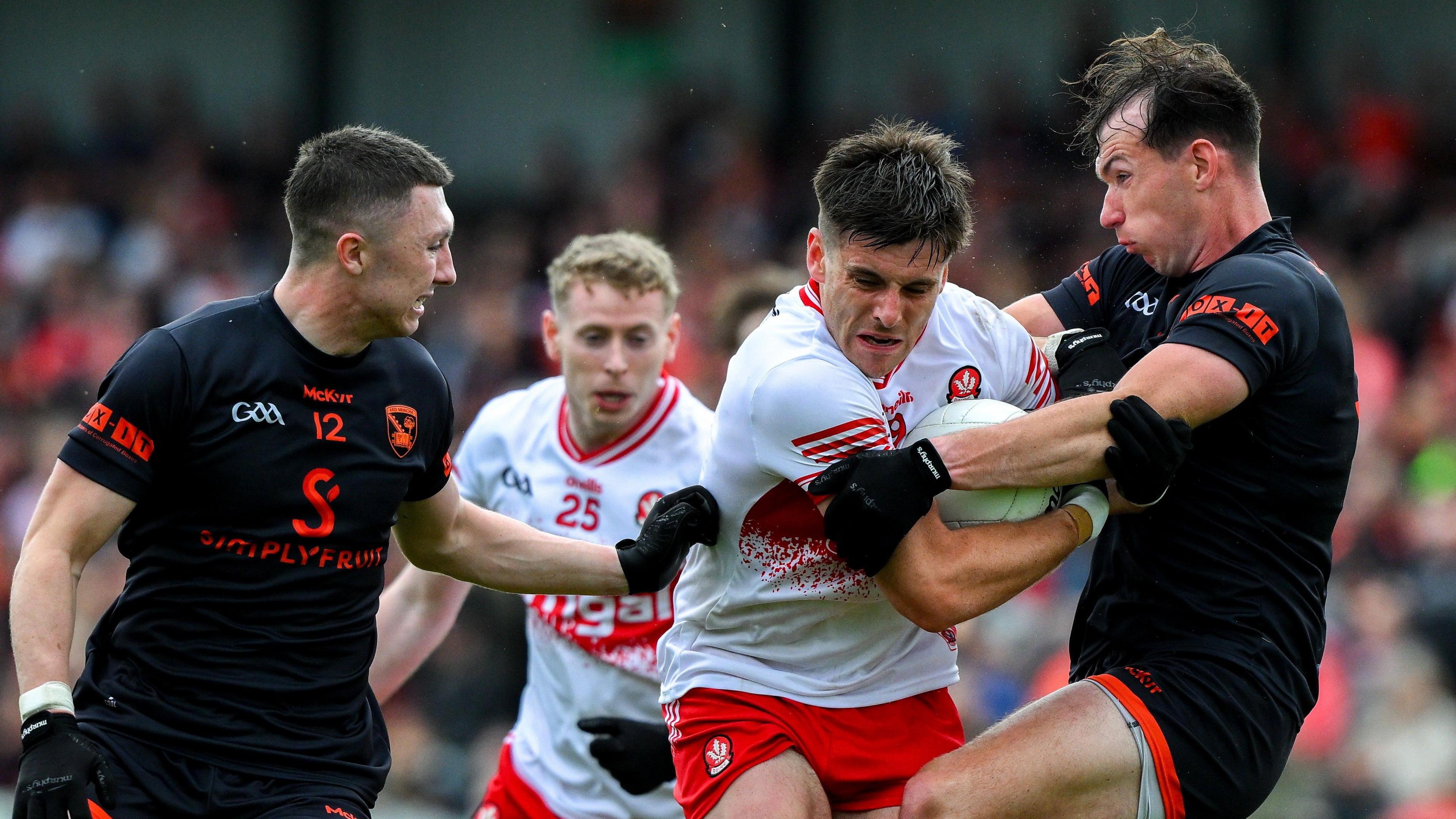 Conor Doherty and Barry McCambridge compete for the ball 