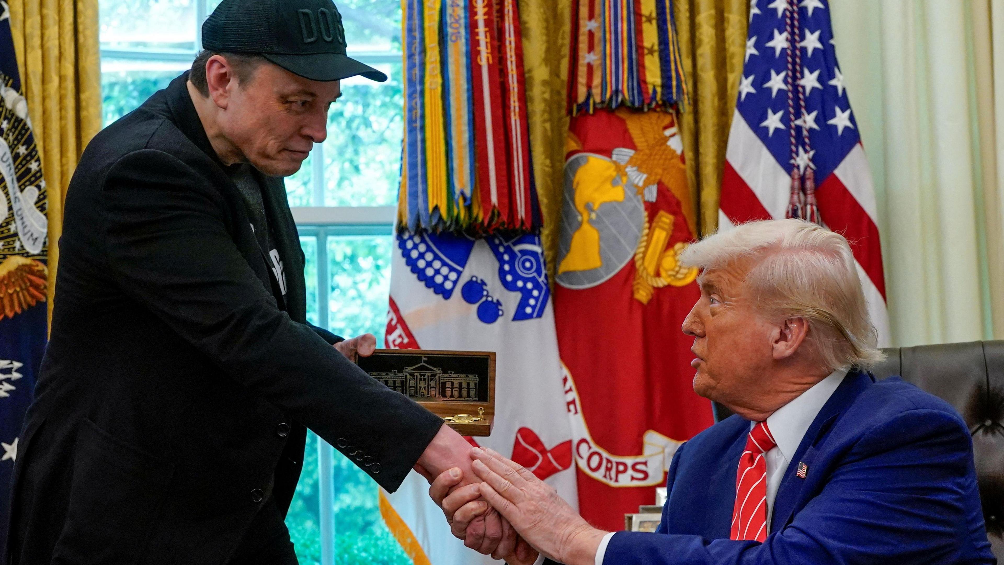 Donald Trump presents Elon Musk with a golden key on his last day in his Doge role