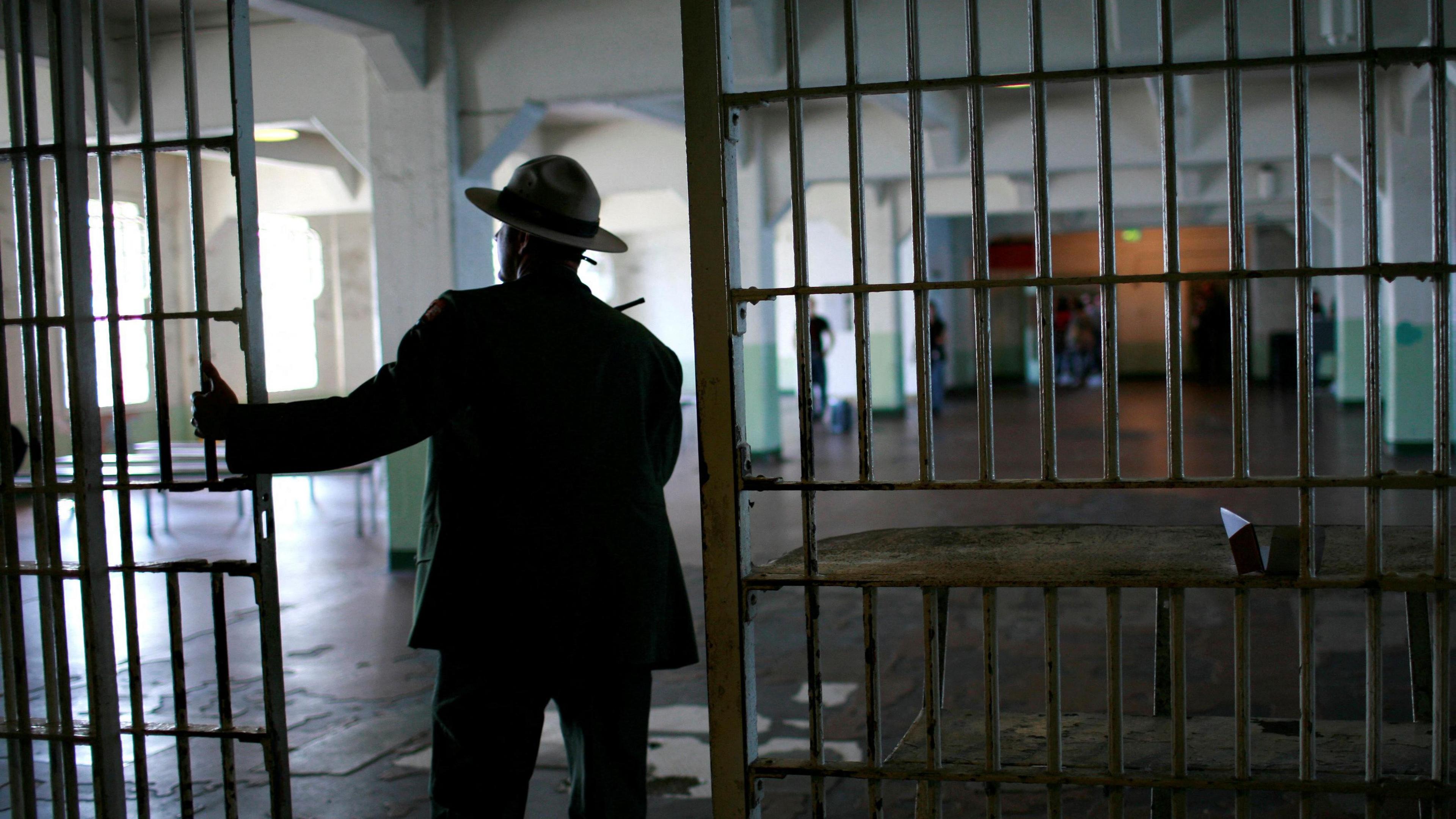 A U.S. National Park Service ranger walks from the kitchen to the dining area at Alcatraz Island