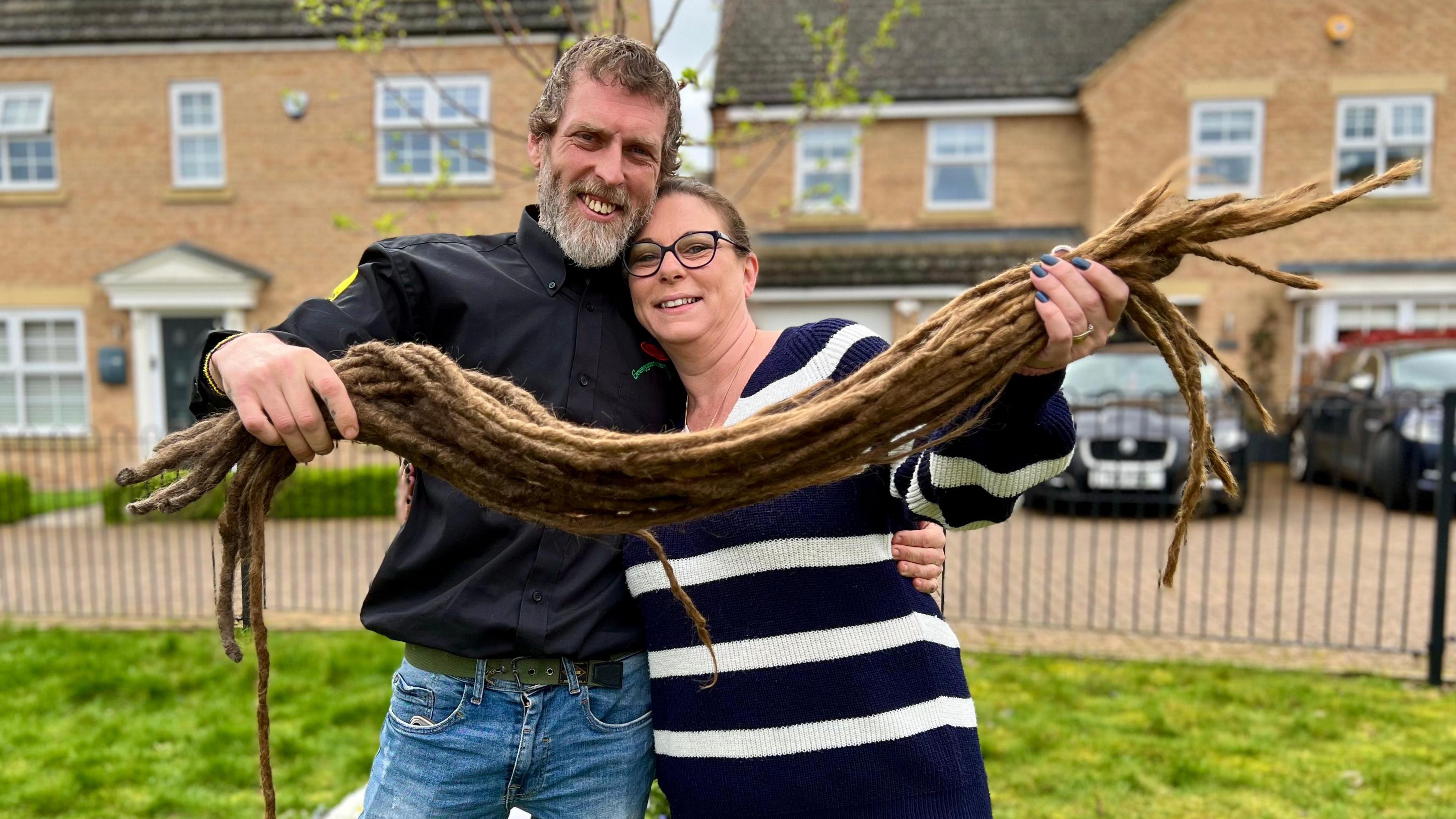 Dave and Jo holding his dreadlocks