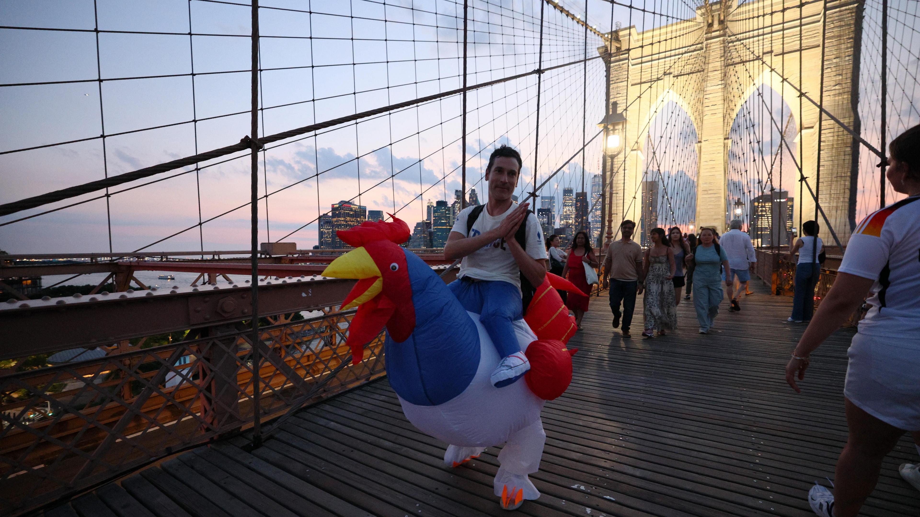 A man wearing a blow up chicken costume seen on Brooklyn Bridge.