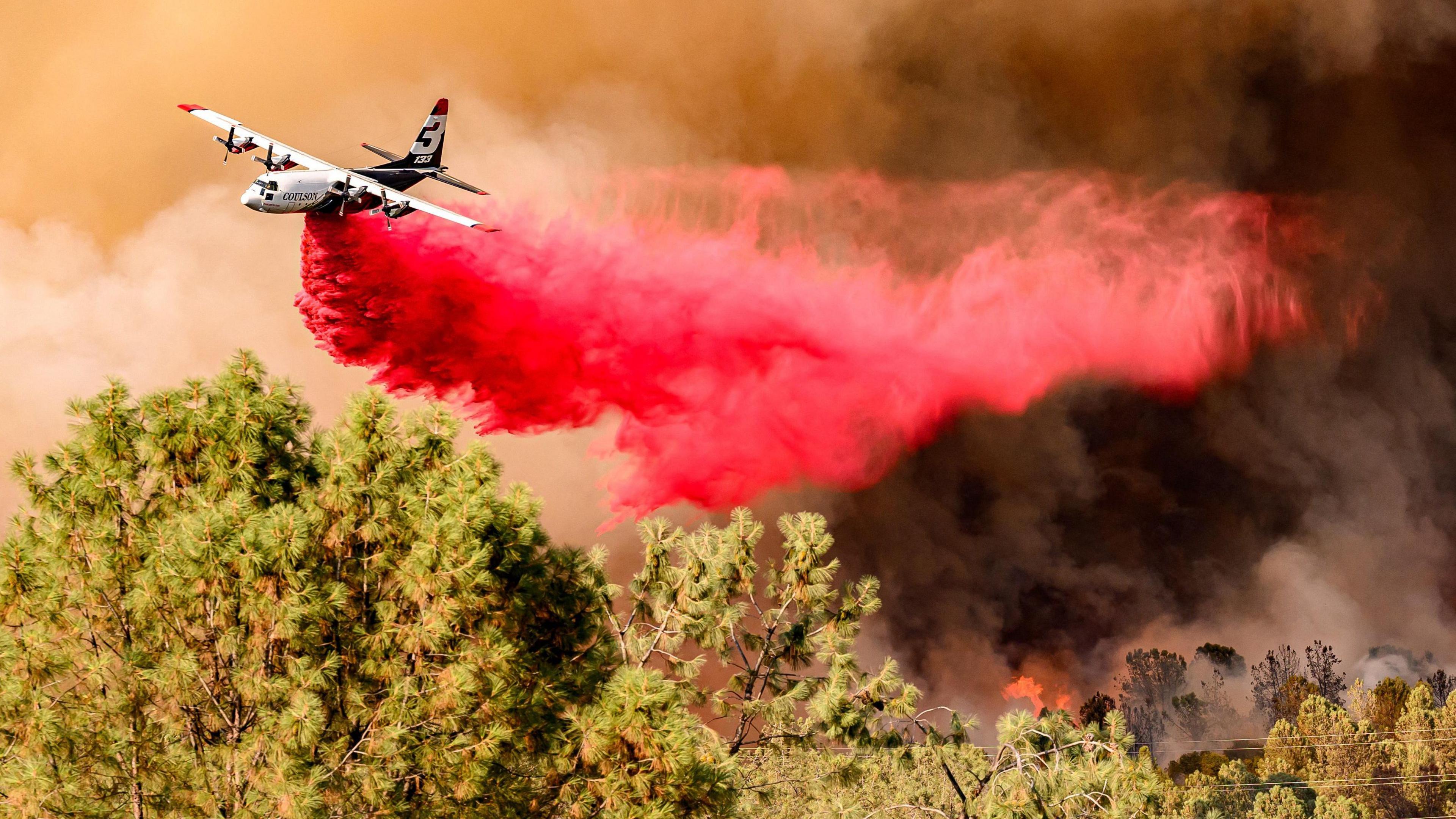 An air tanker drops fire retardant during the Thompson fire in Oroville, California on 2 July, 2024