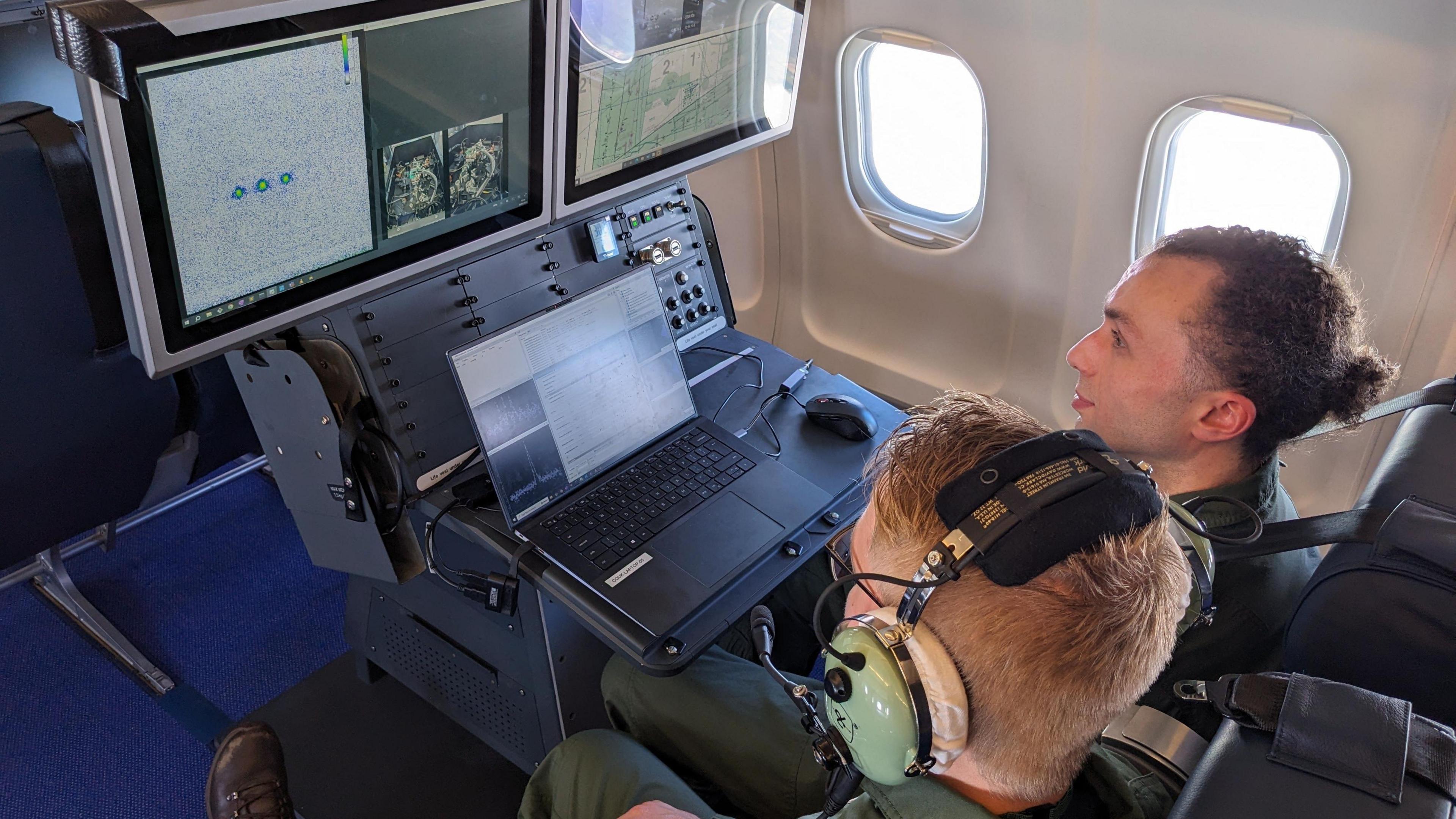 An over the shoulder photograph of inside the test flight with navigation screens visible