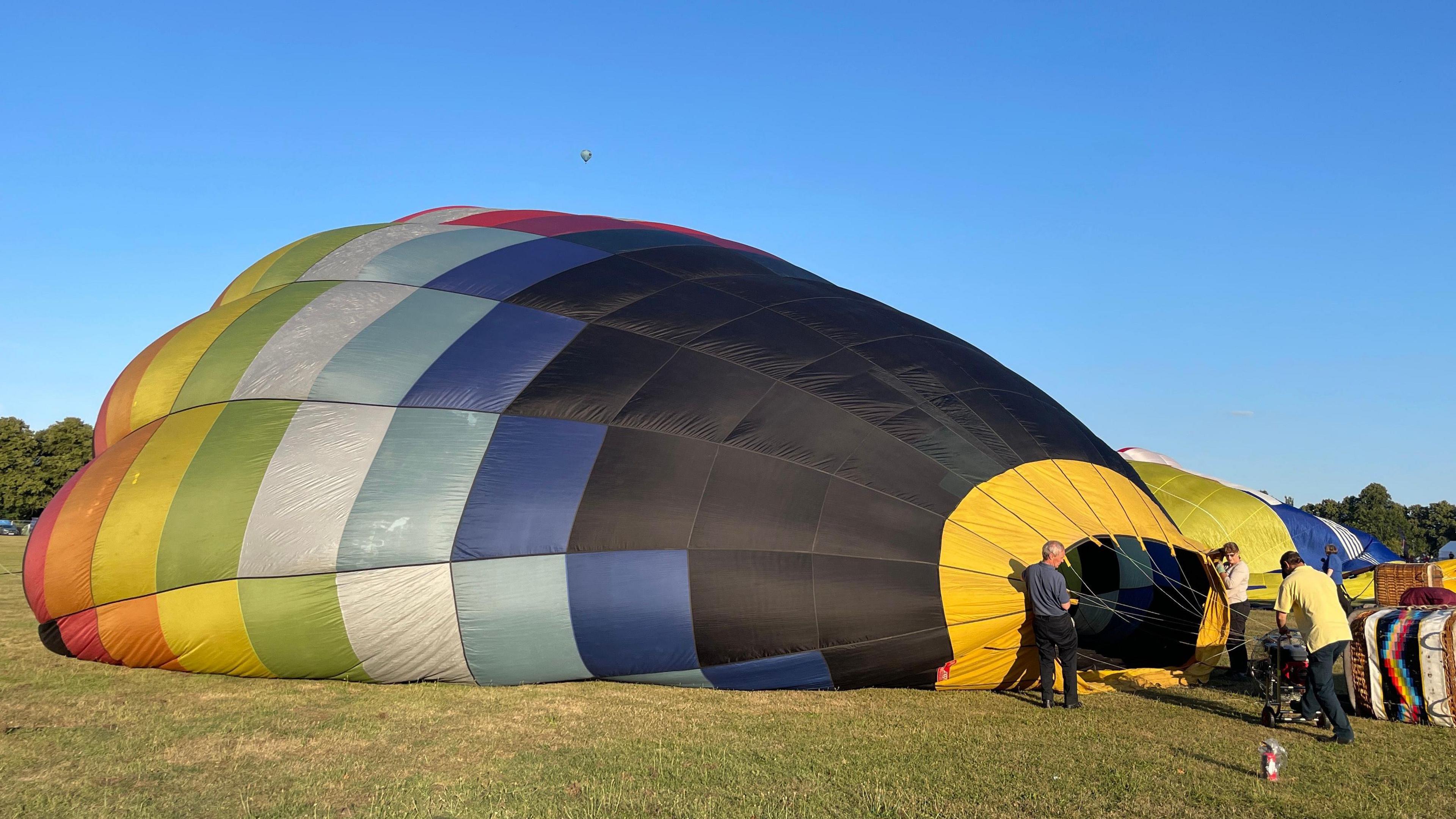 General view of a hot air balloon being inflated at Northampton's Racecourse