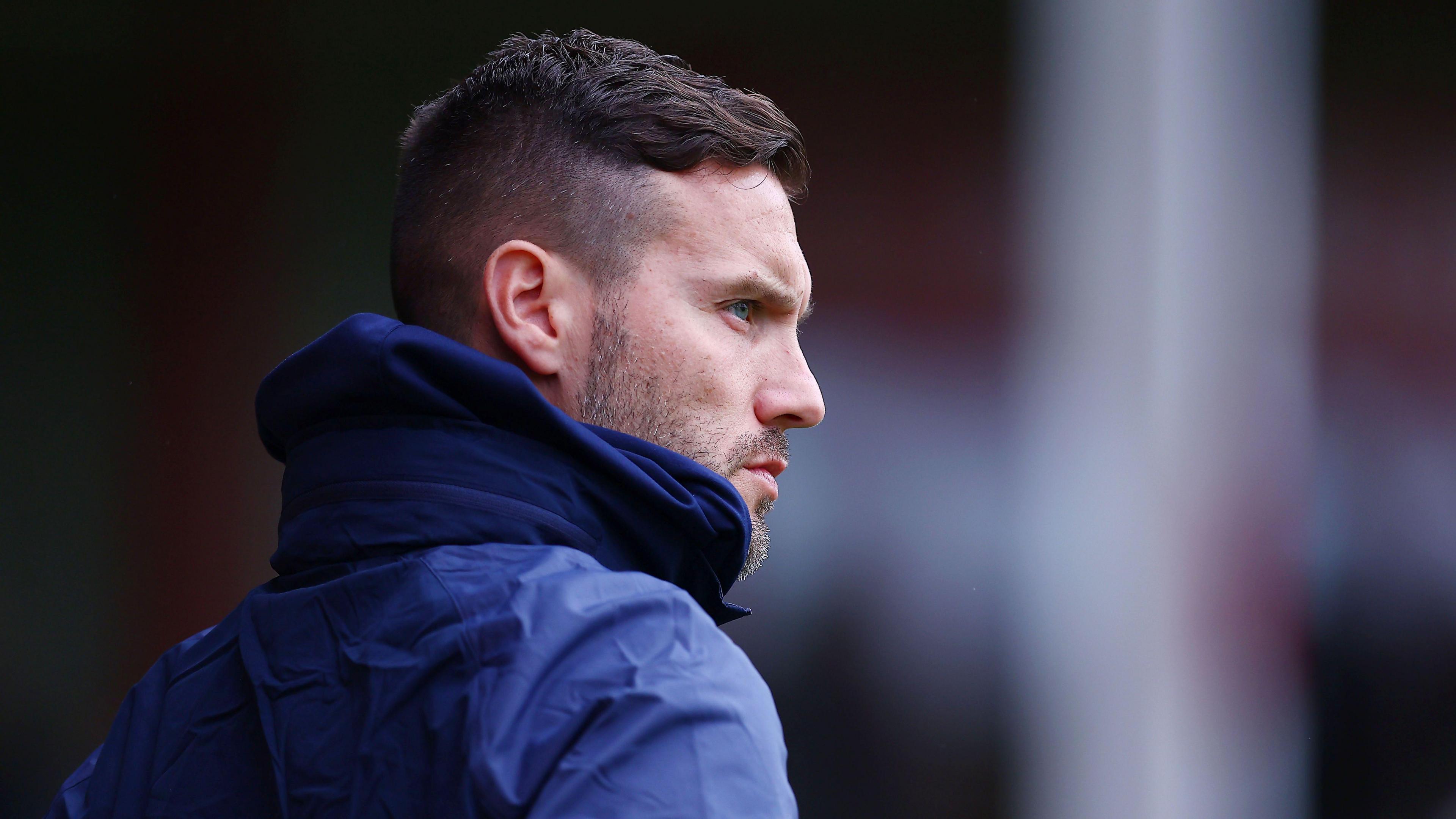 A profile picture of Mat Sadler on the touchline