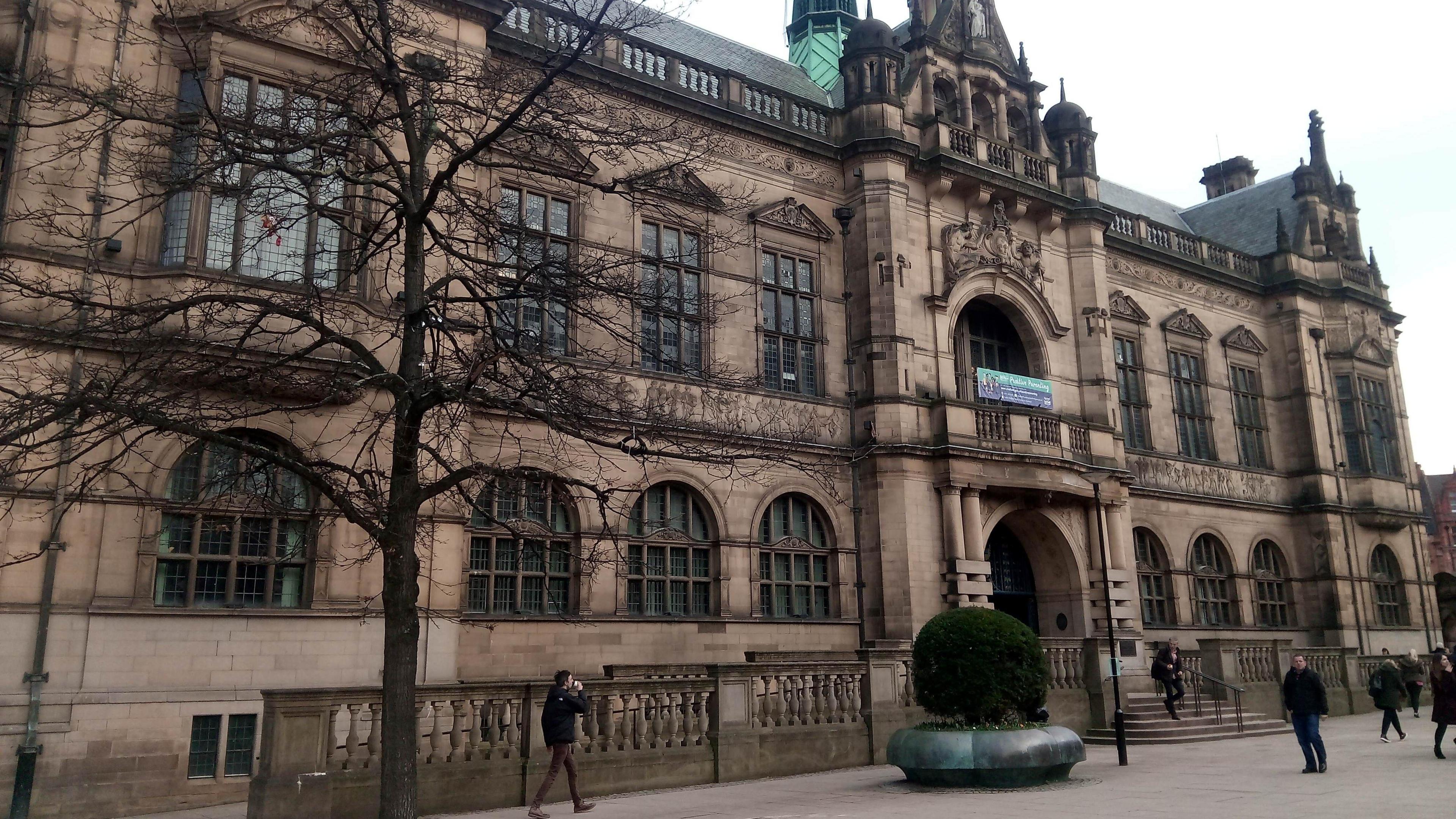 Sheffield town hall is a goth style Victorian building with large windows, a balcony and ornate stone decoration