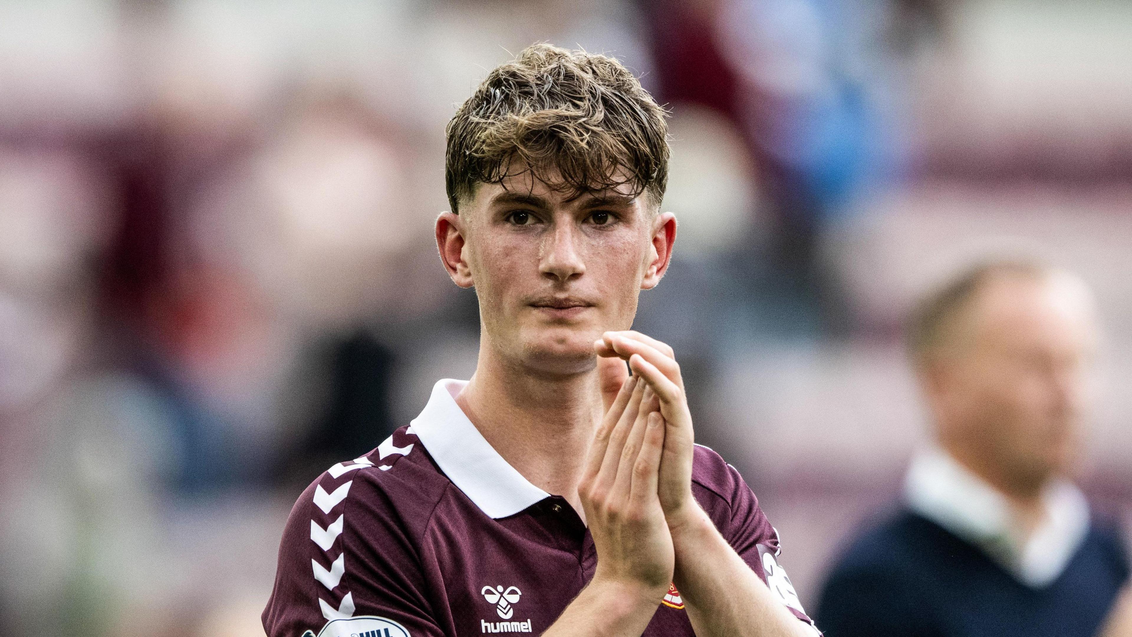 James Wilson applauds fans at Tynecastle