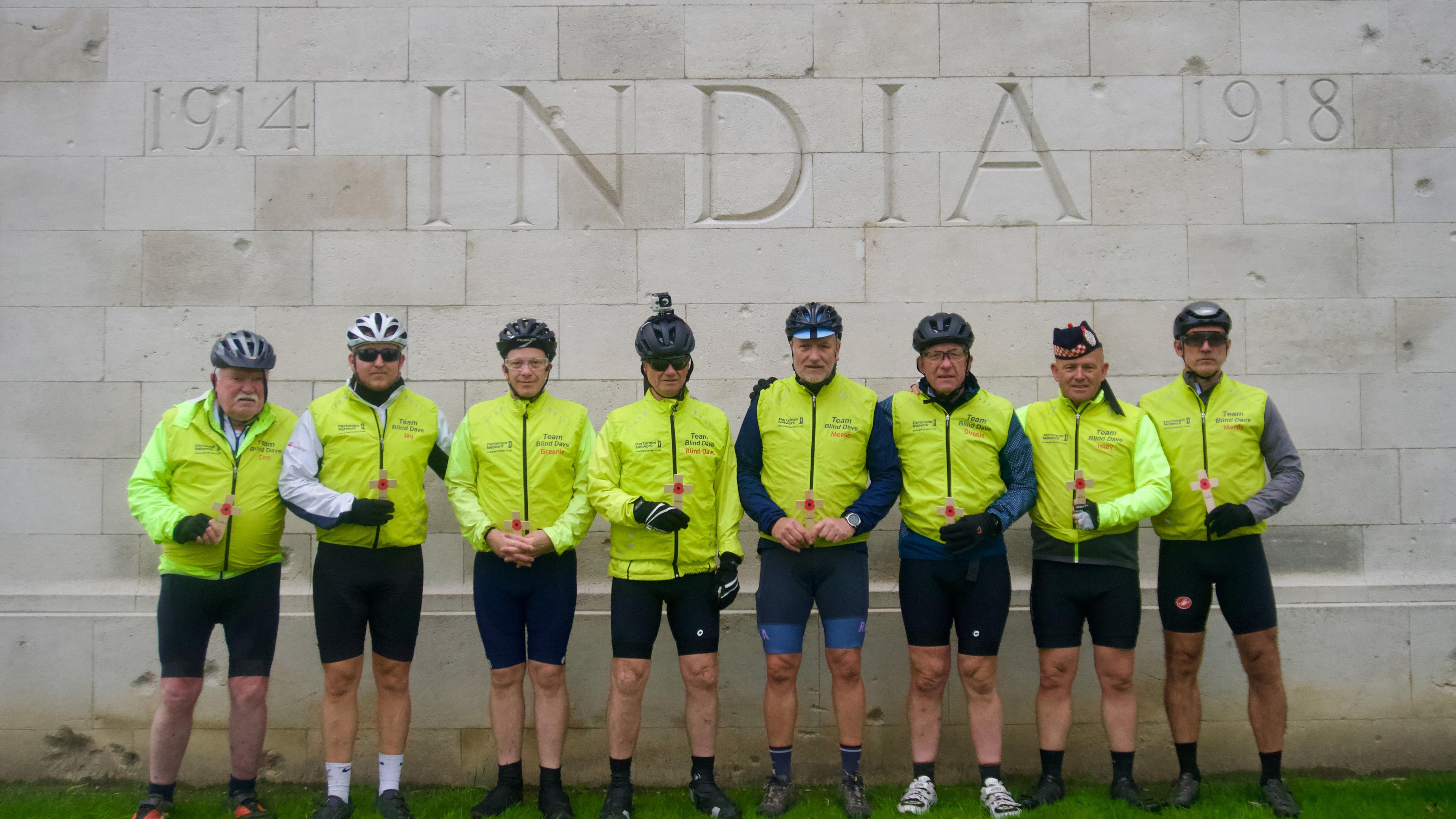 Eight cyclists at an Indian war memorial