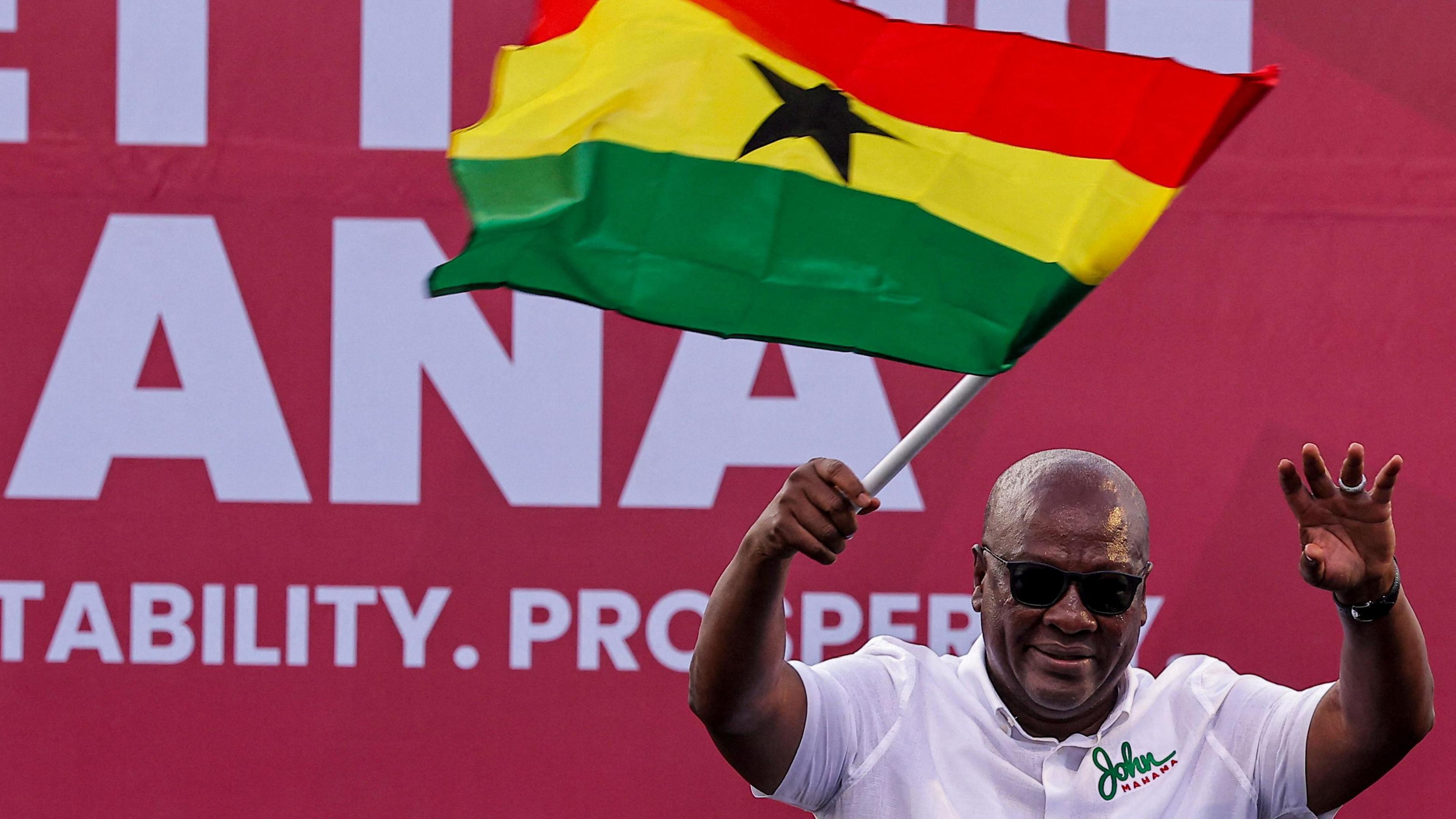 National Democratic Congress (NDC) presidential candidate and former Ghanaian President John Dramani Mahama holds a national flag as he waves to supporters during his final election campaign rally in Accra, Ghana - 5 December 2024