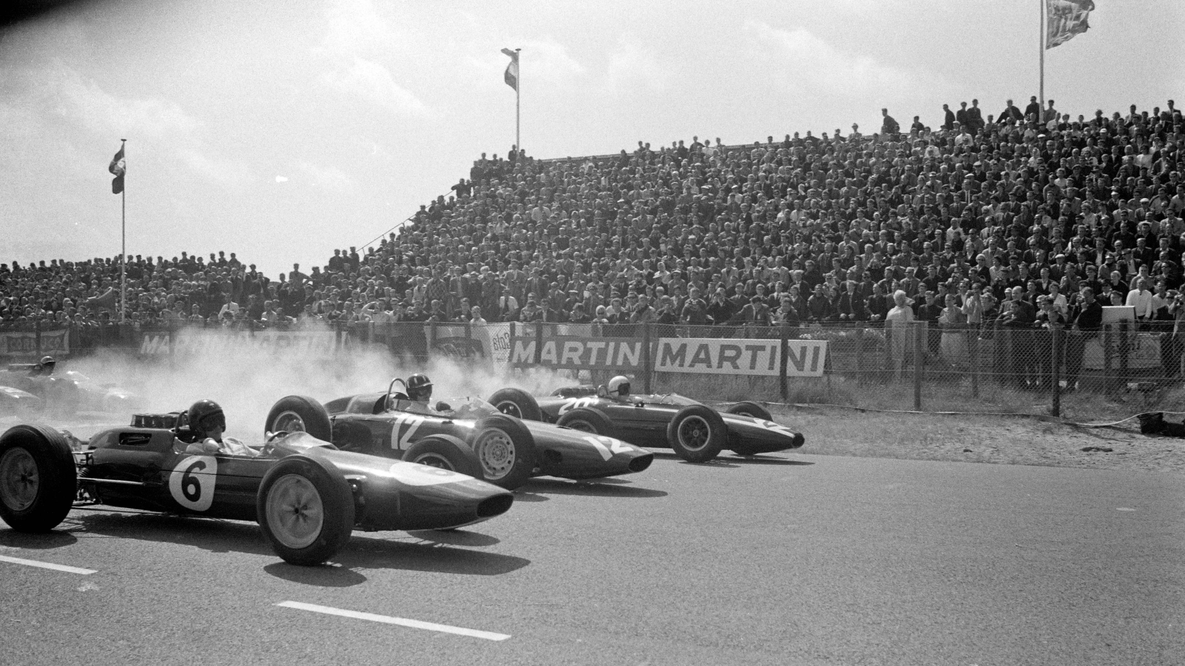 Smoke comes up from the tyres as Bruce McLaren, Jim Clark and Graham Hill lead the field away at the start of the 1963 Dutch Grand Prix