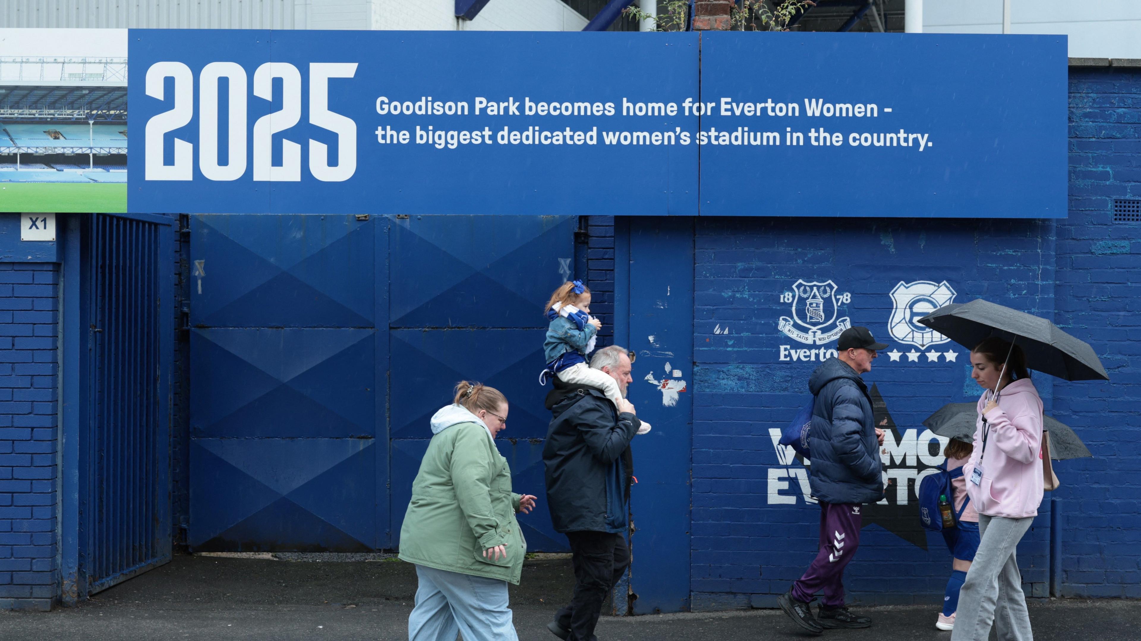 Fans walk past sign at Goodison Park, Liverpool, before women's match against Tottenham