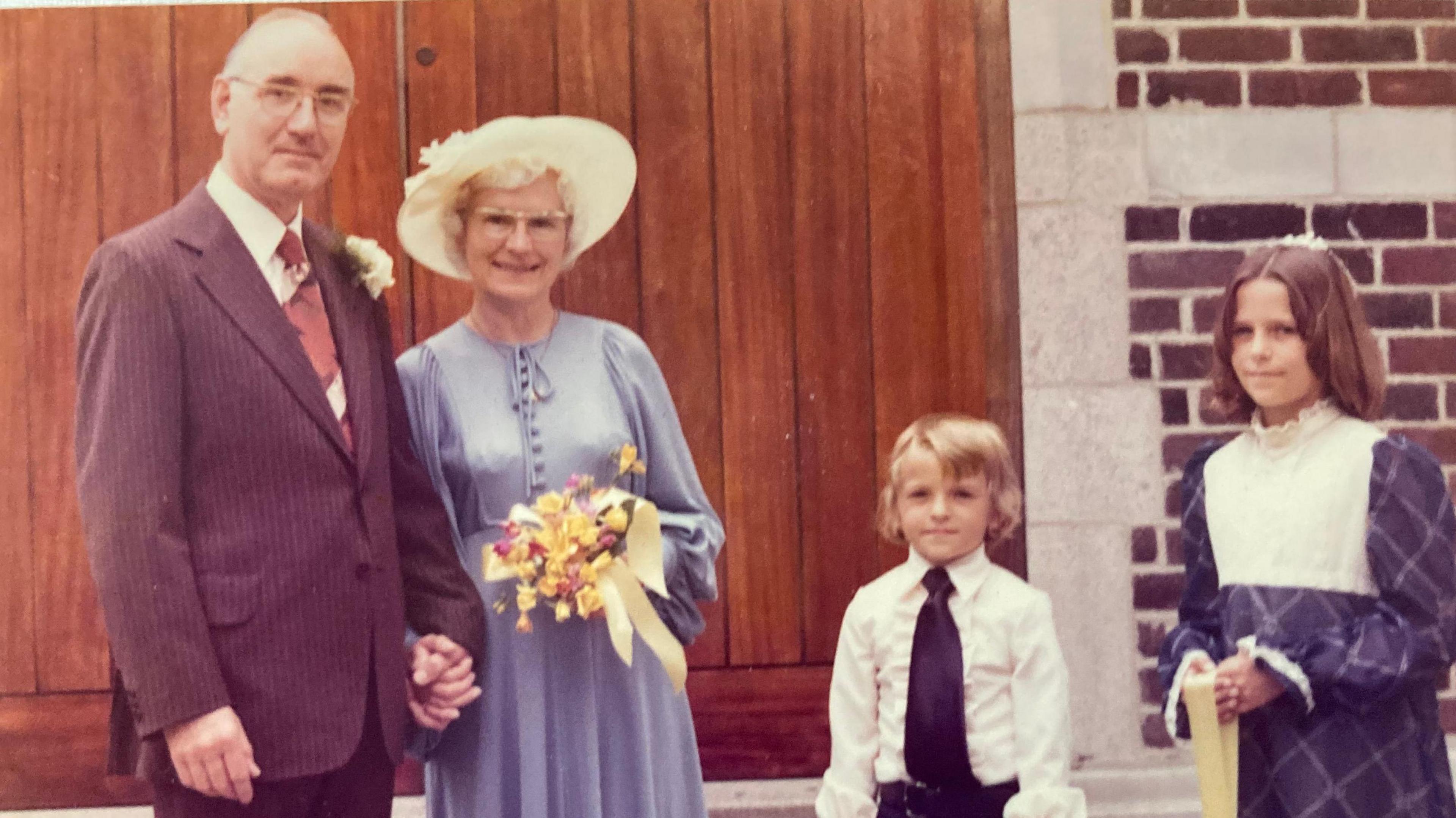 A wedding photo from the 1970s showing Mr and Mrs Green, and Mrs Green's grandchildren Julia and Scott. 