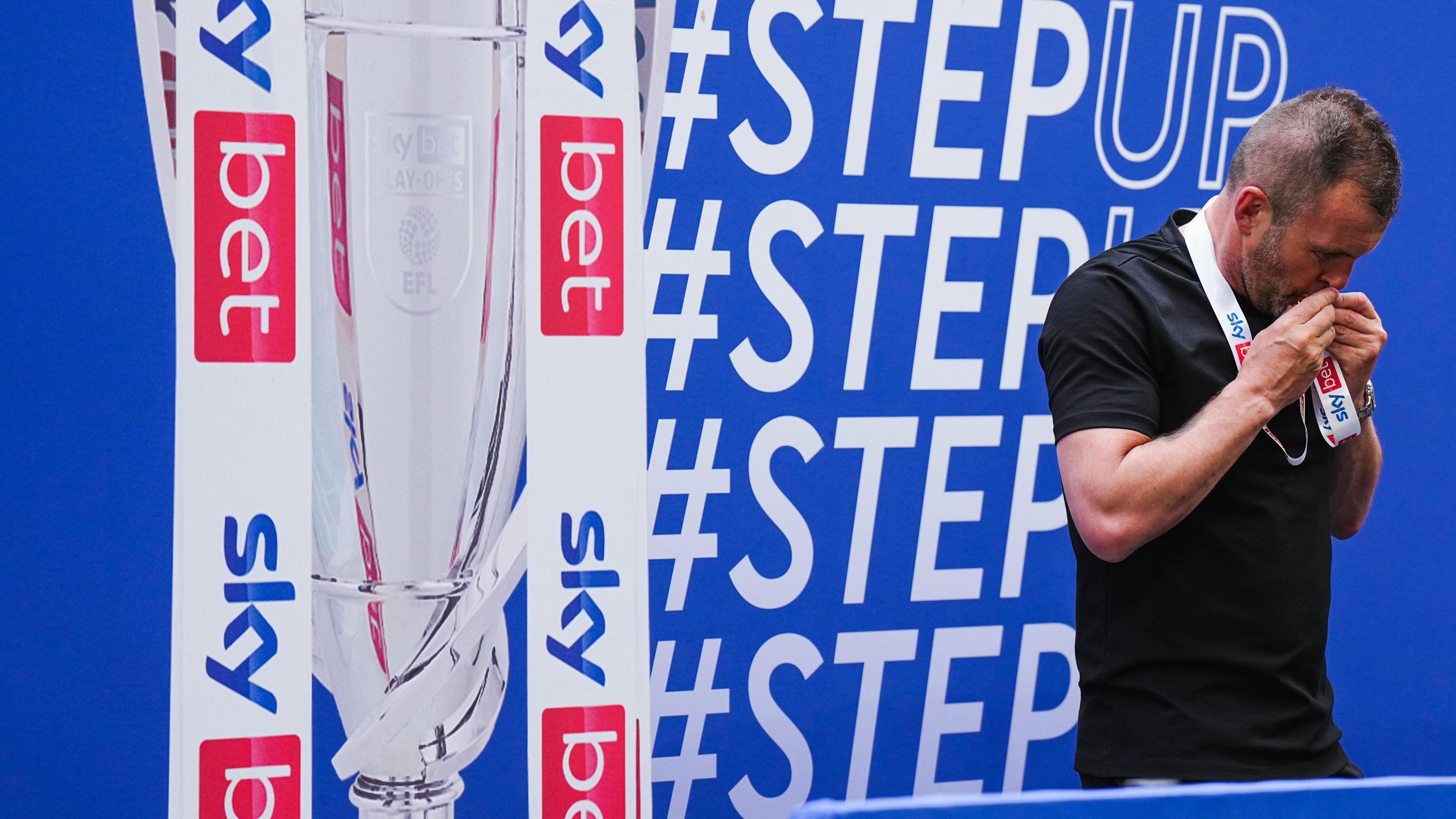 Nathan Jones kisses his League One play-off final winner's medal