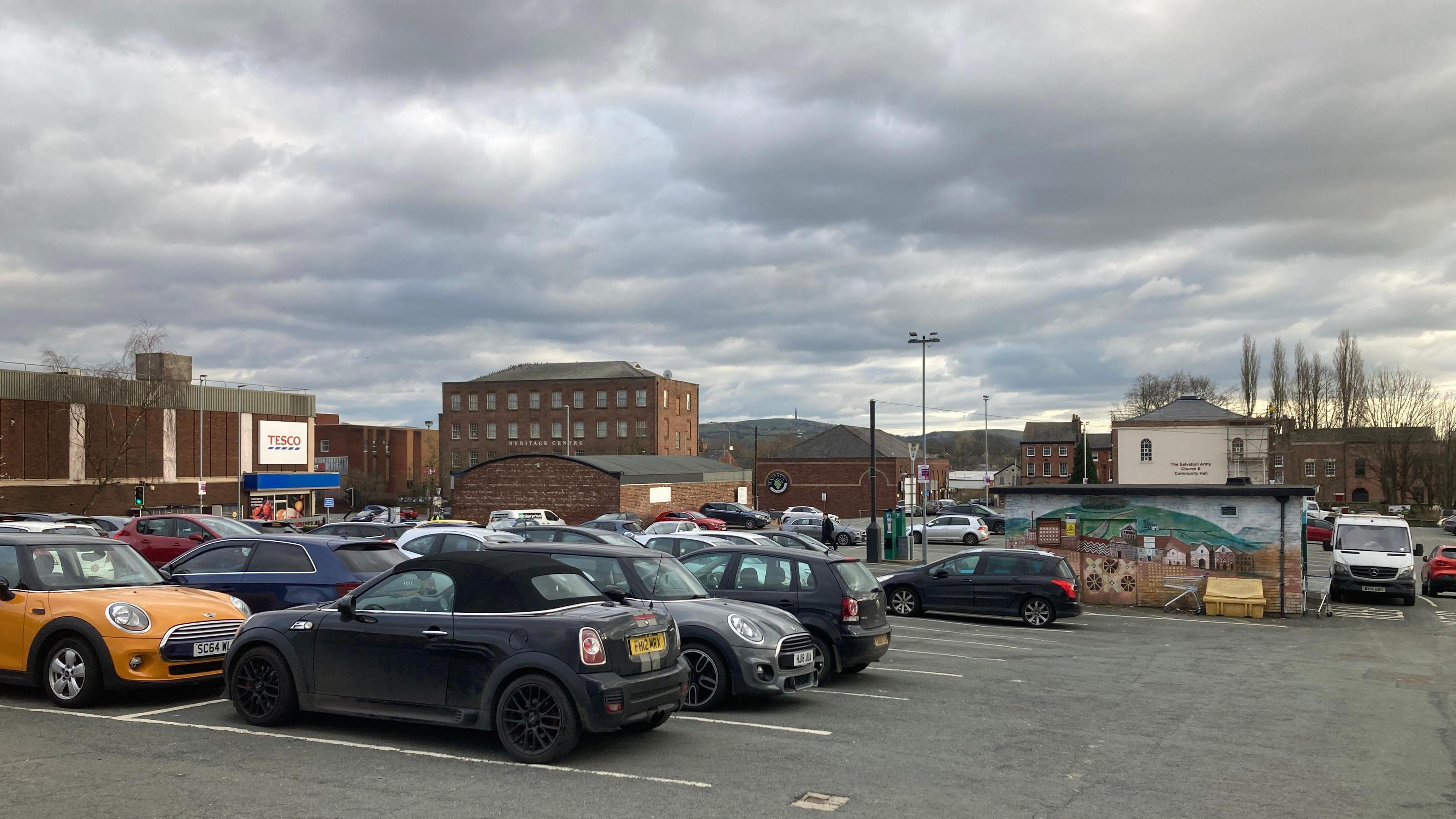 Churchill Way car park in Macclesfield, Cheshire. A view of the car park with buildings and hills in the background.