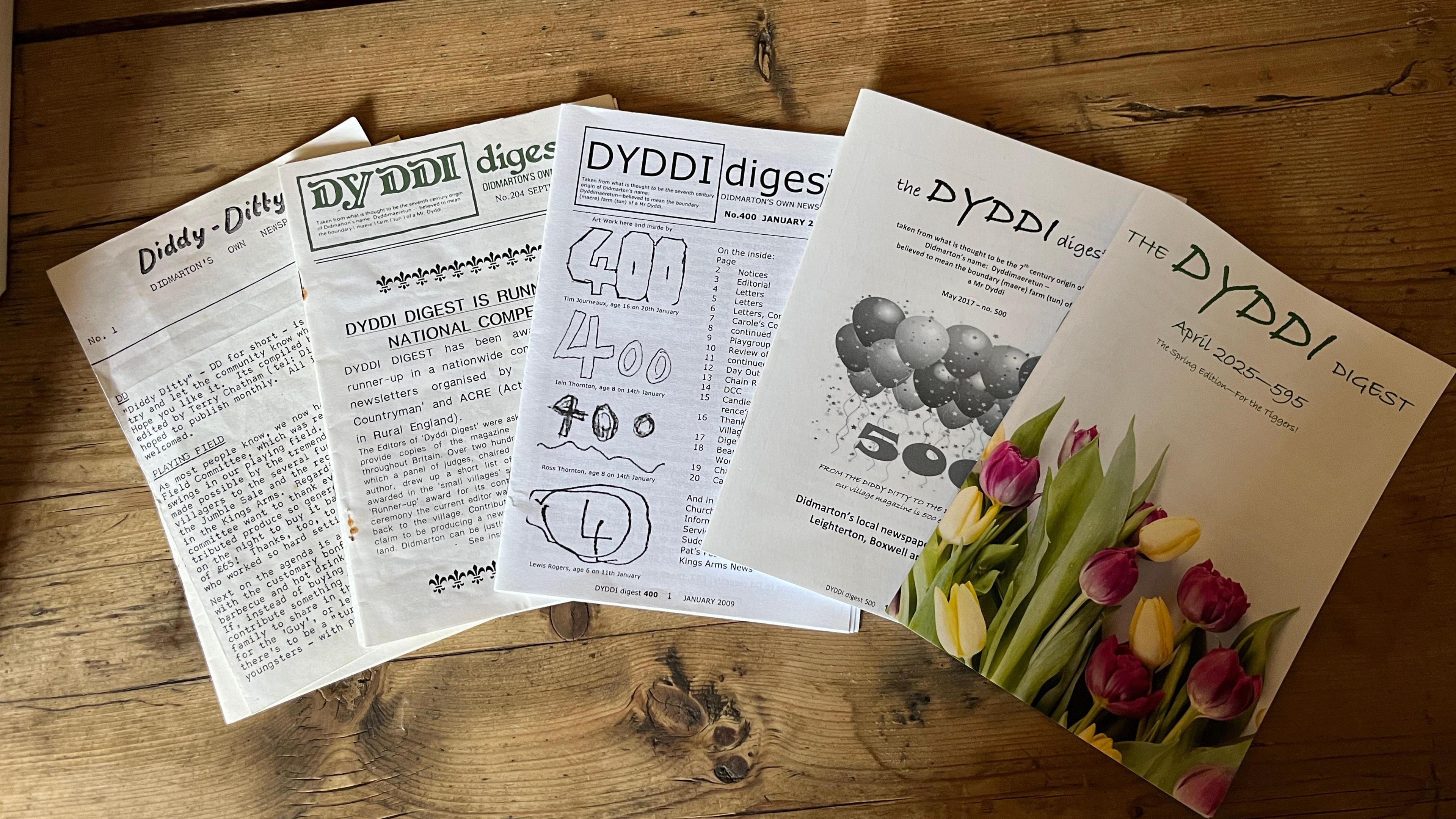 Five examples of the front page of the Dyddi newspaper through time, starting on the left with the first edition, and through to one from 2025 on the right. 