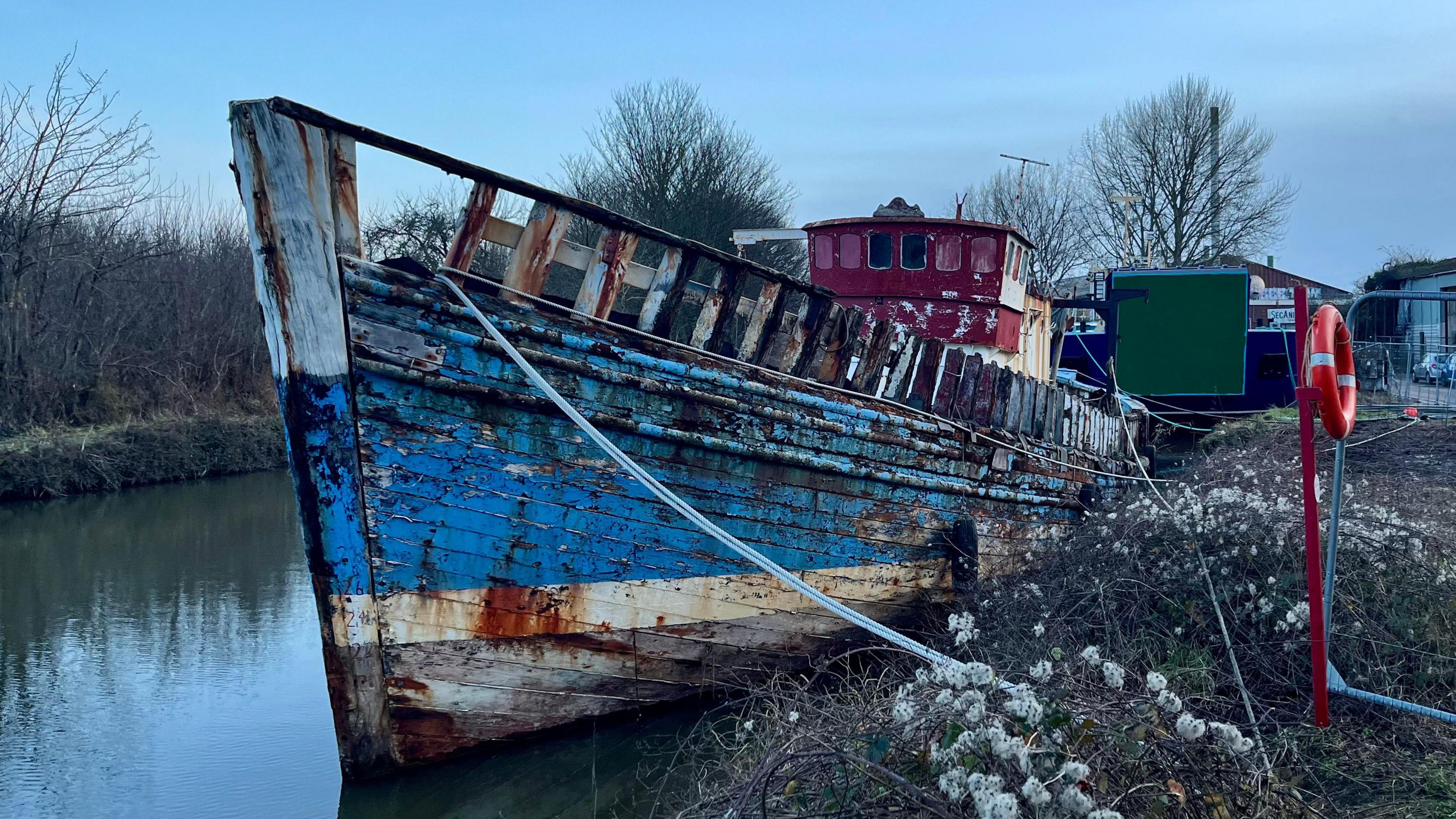 A dilapidated boat in the water at Exeter canal