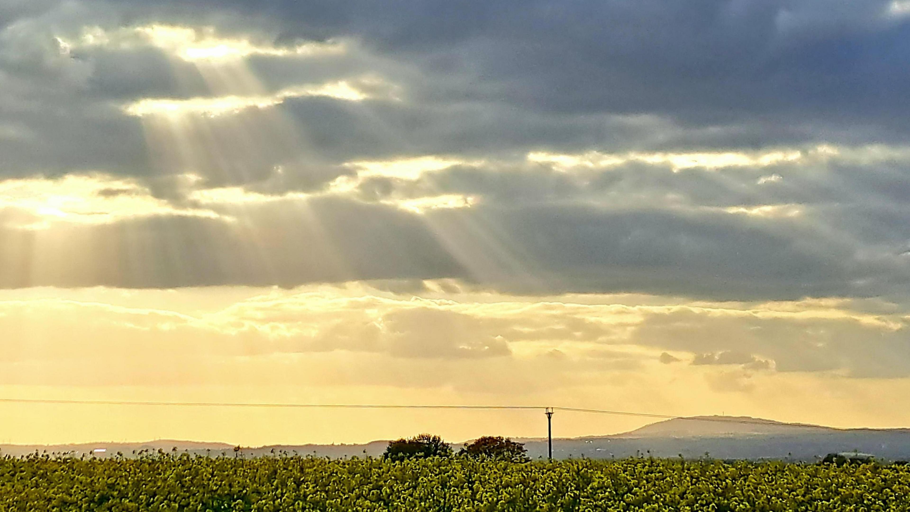 The sun's rays through the clouds