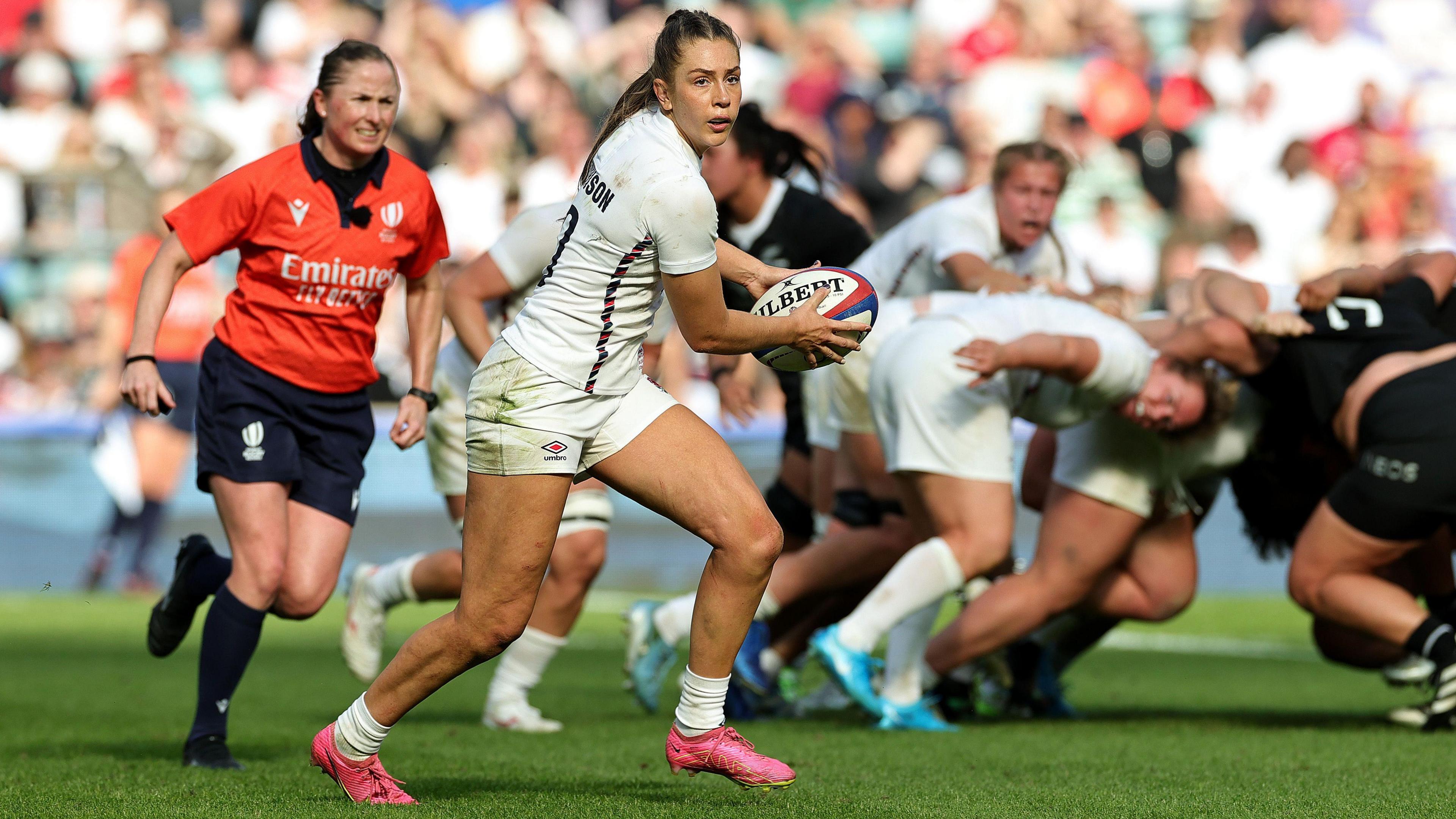 Holly Aitchison running with the ball while playing for England