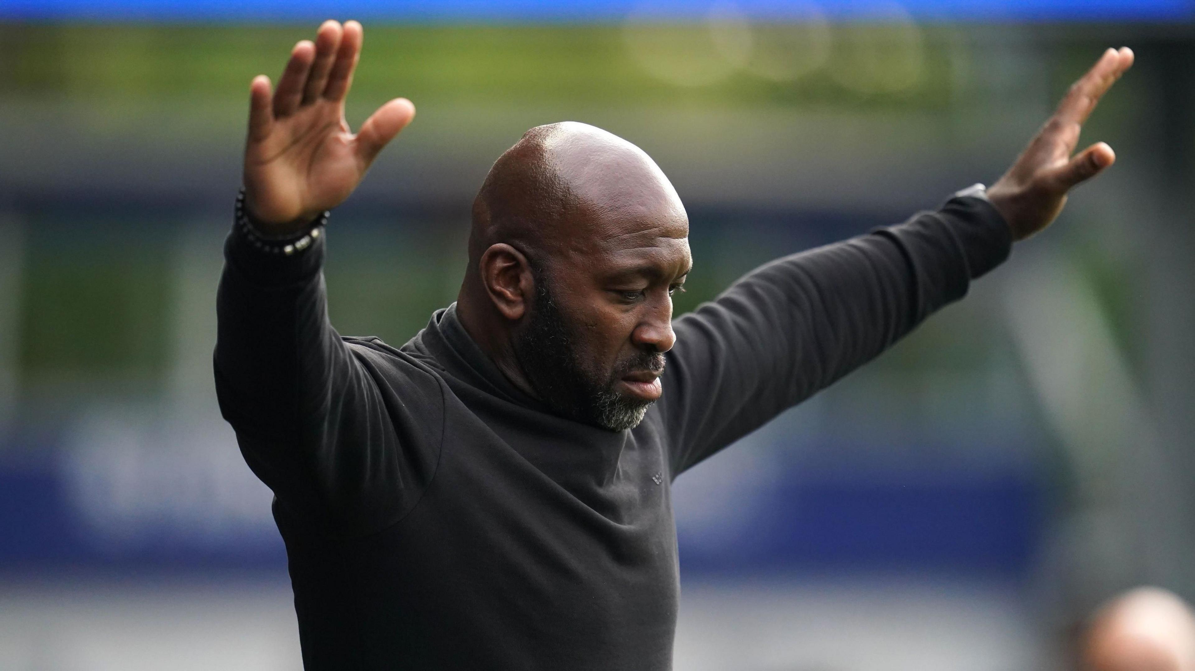 Darren Moore with his arms aloft