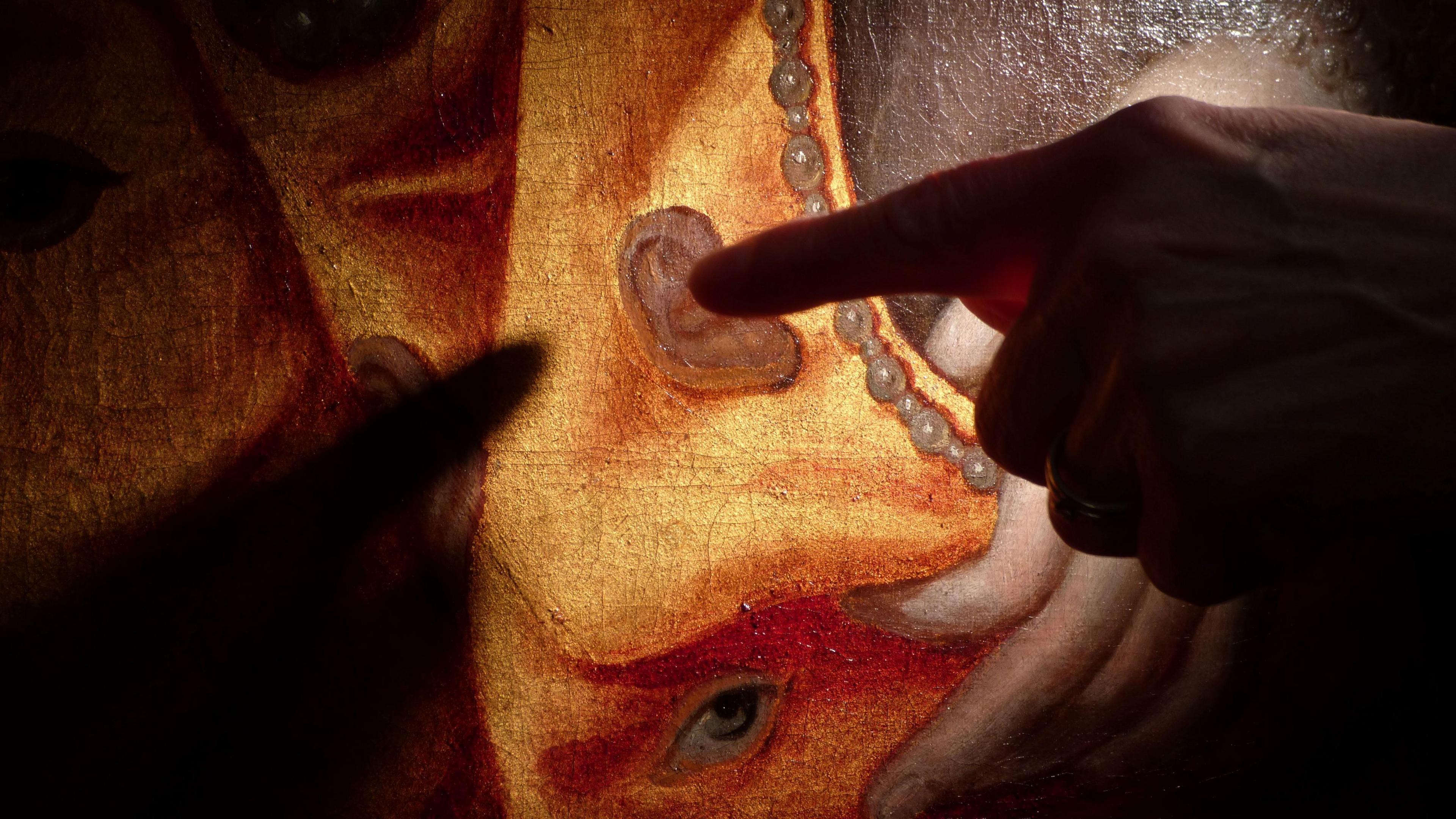 A painting of Queen Elizabeth I being restored, with a finger being pointed to an ear 