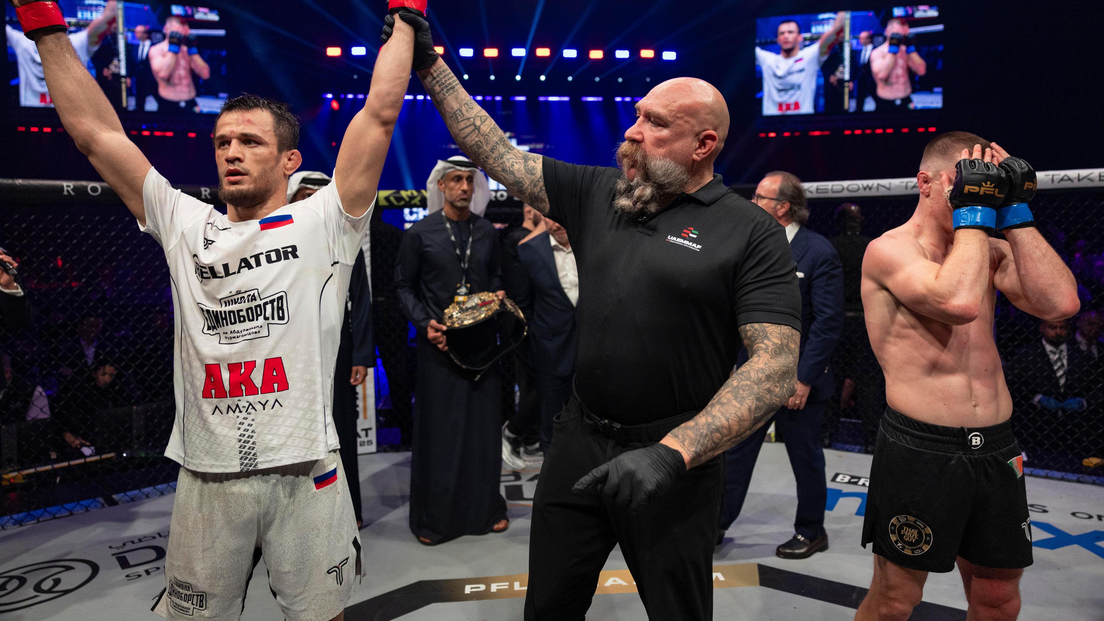 Usman Nurmagomedov celebrates as Paul Hughes is dejected