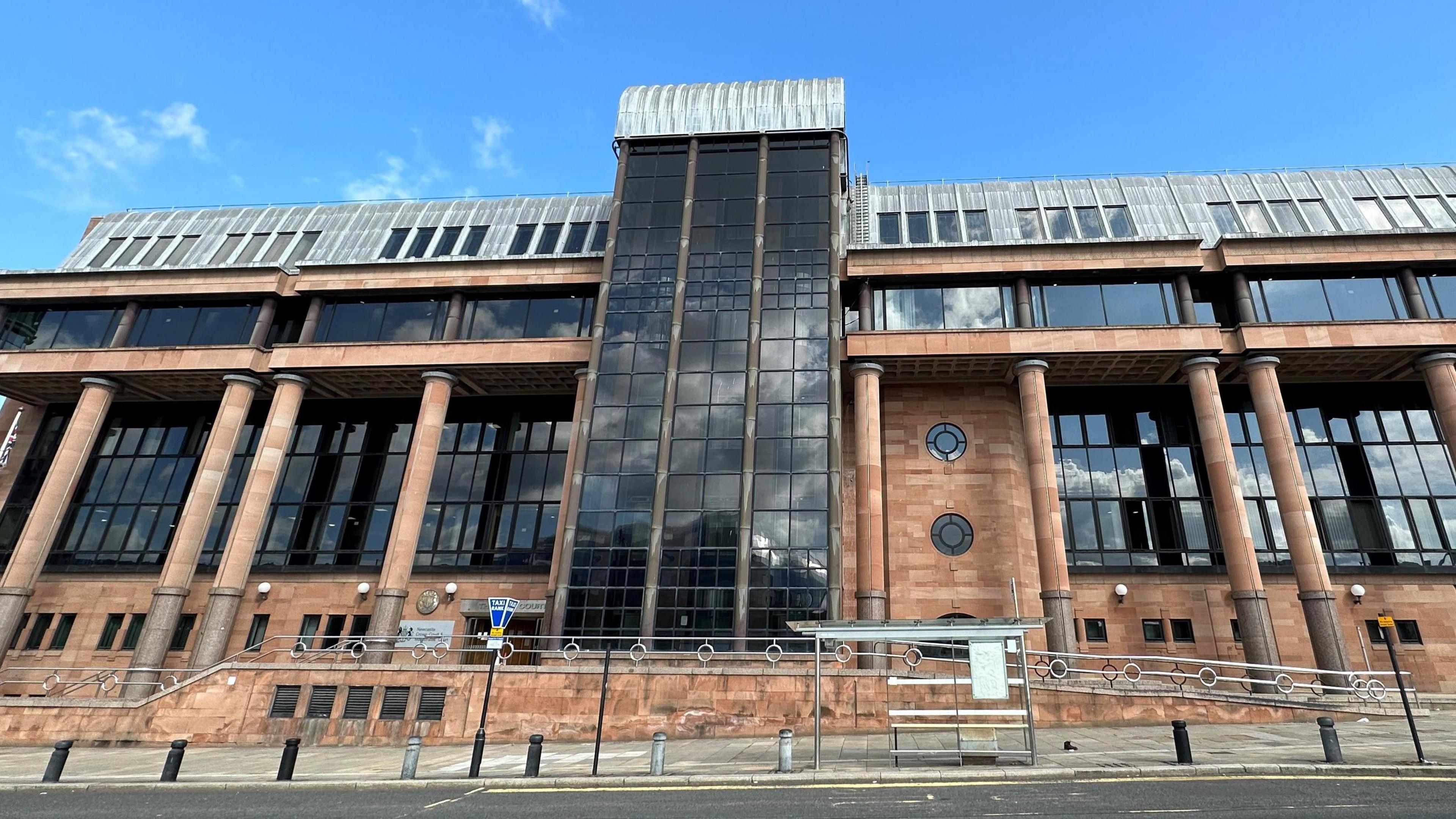 Newcastle crown court, it is made from red bricks and has large dark windows