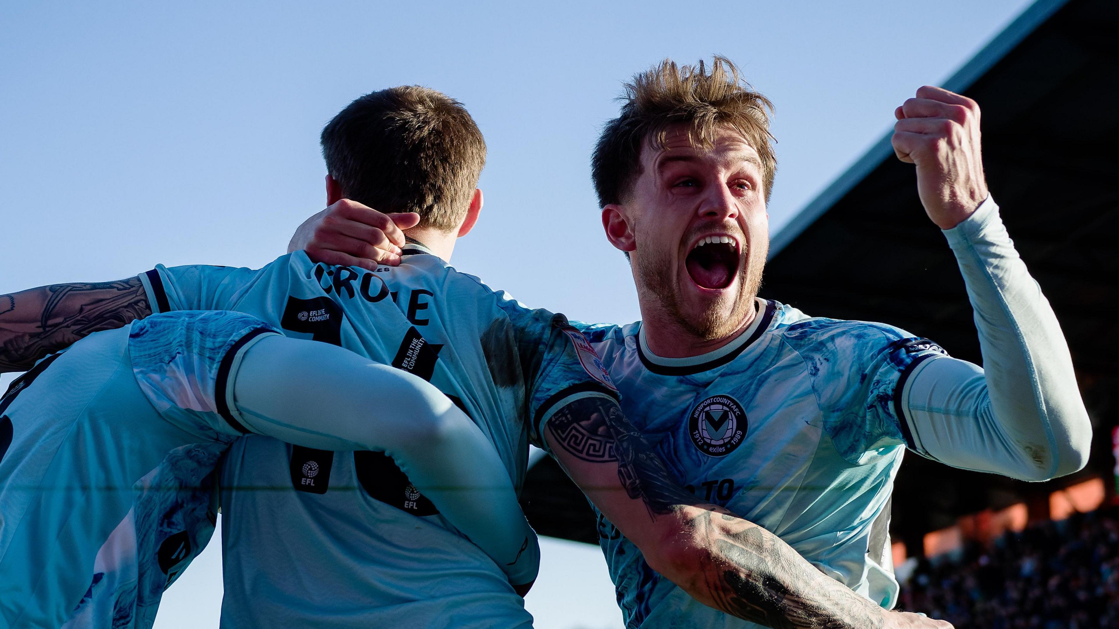 James Crole of Newport County celebrates his goal with Ben Lloyd