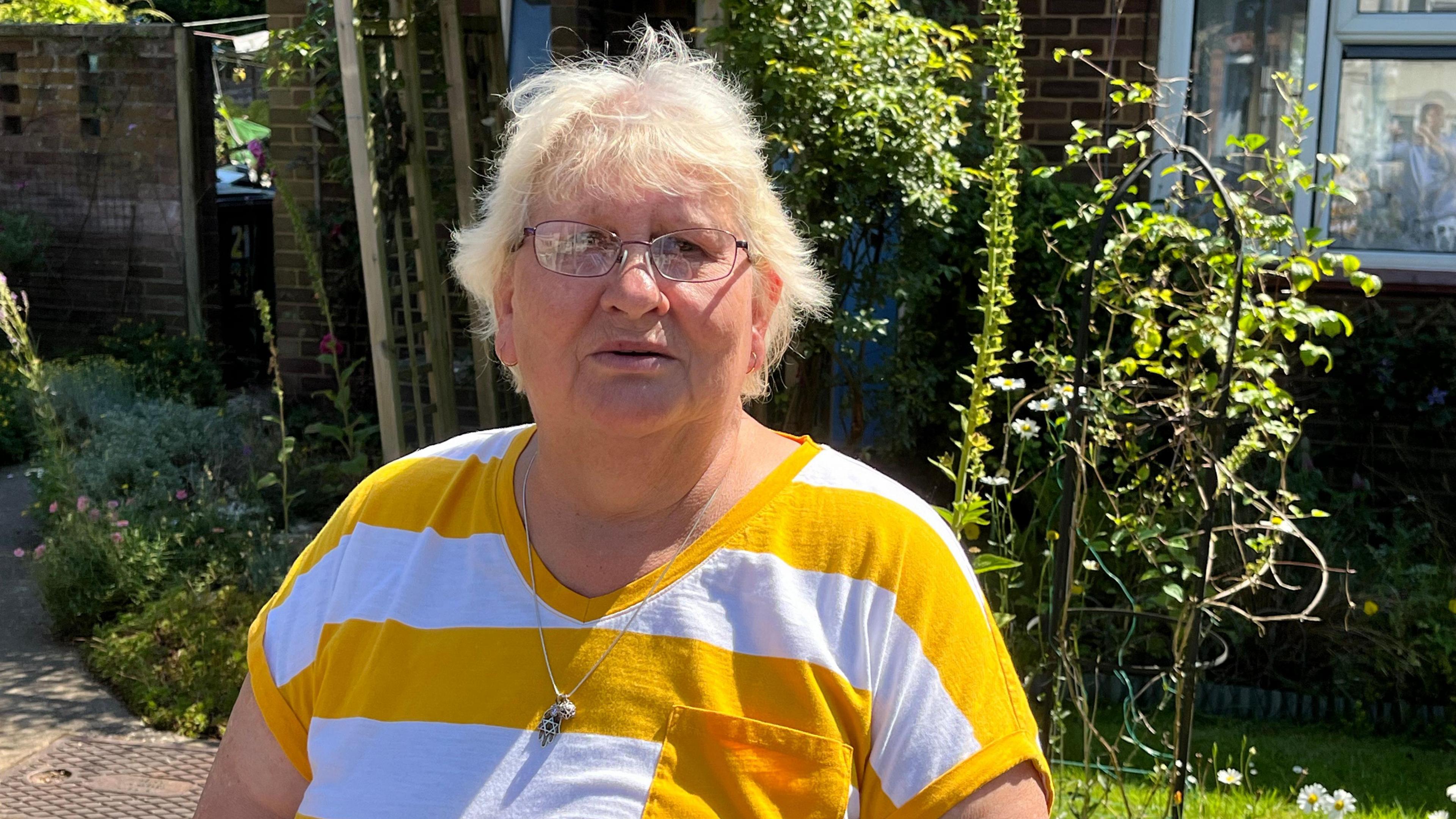 Lynda Kopper outside her Ekin Road home