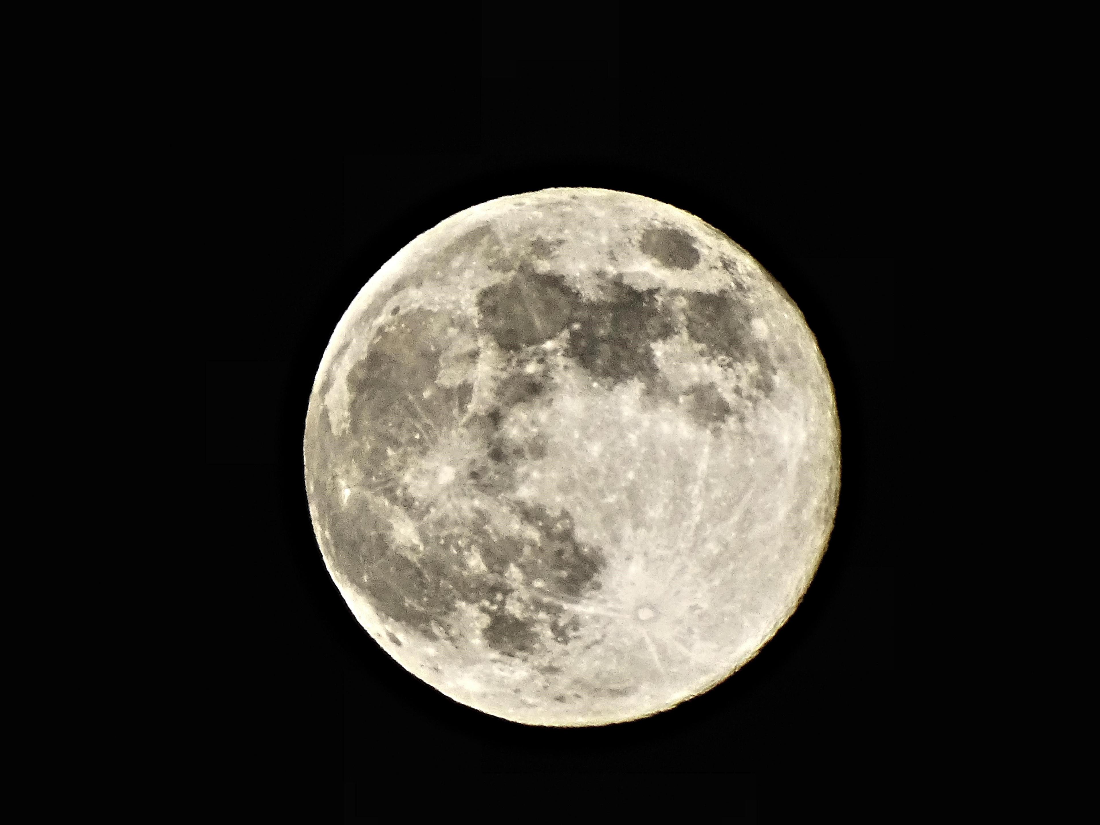 Full moon with craters and hills visible