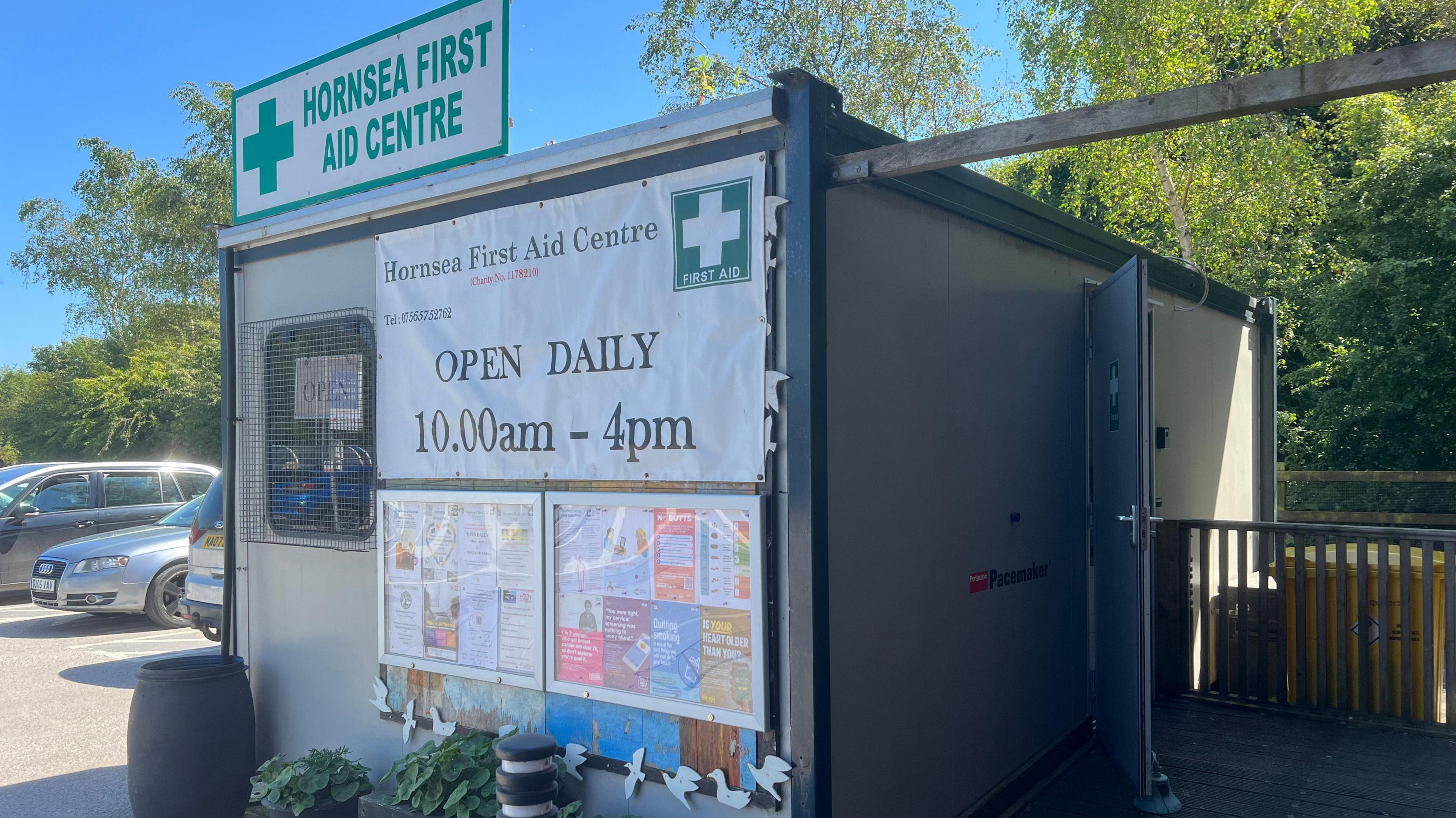 Hornsea first aid centre, a small portable, grey cabin, in a car park  