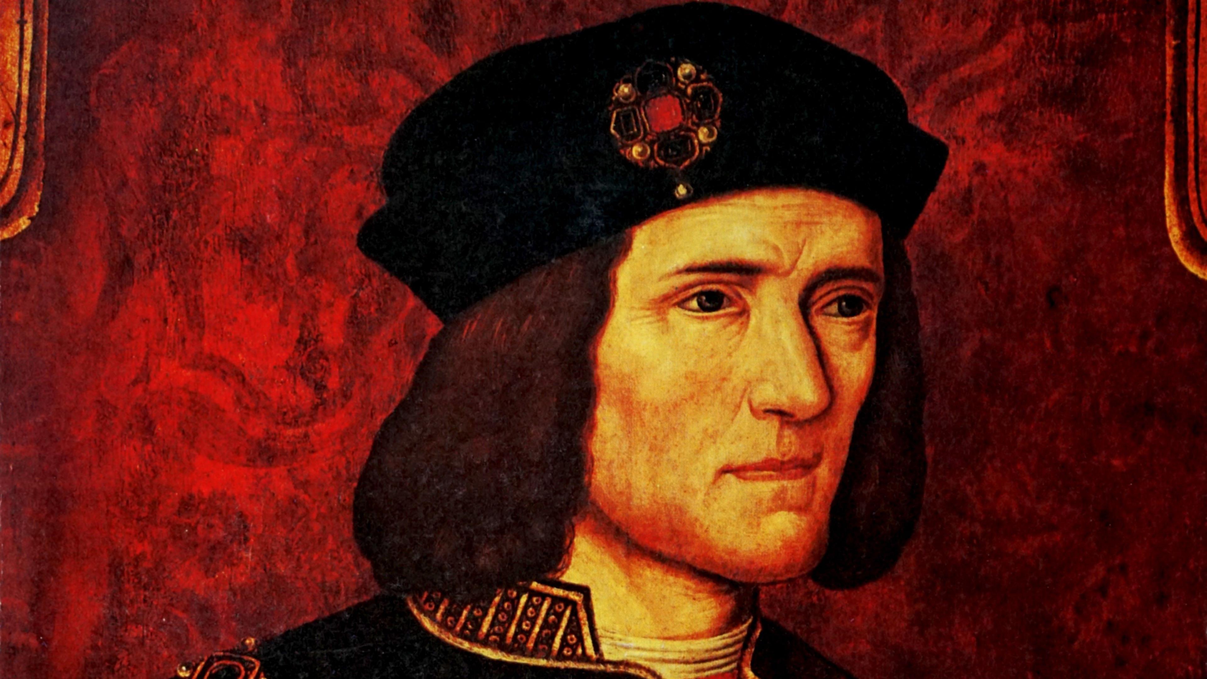 A portrait of Richard III. He is wearing a black hat, with a brooch on it and has long brown hair.