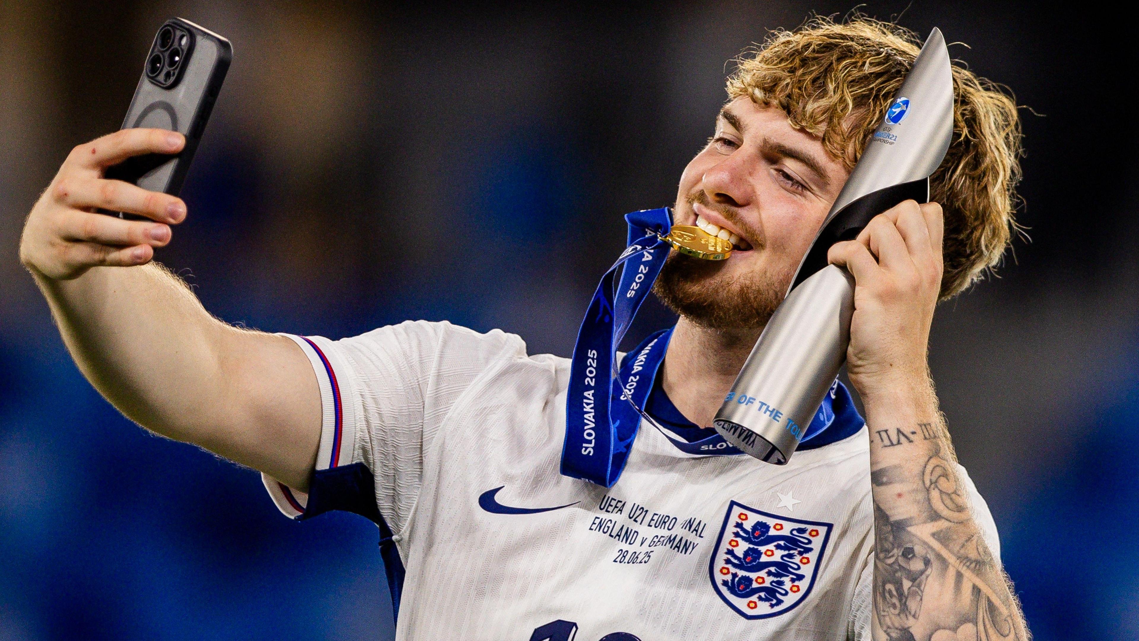 Harvey Elliott celebrates England Under-21s' Euro 2025 win while holding his player of the tournament trophy
