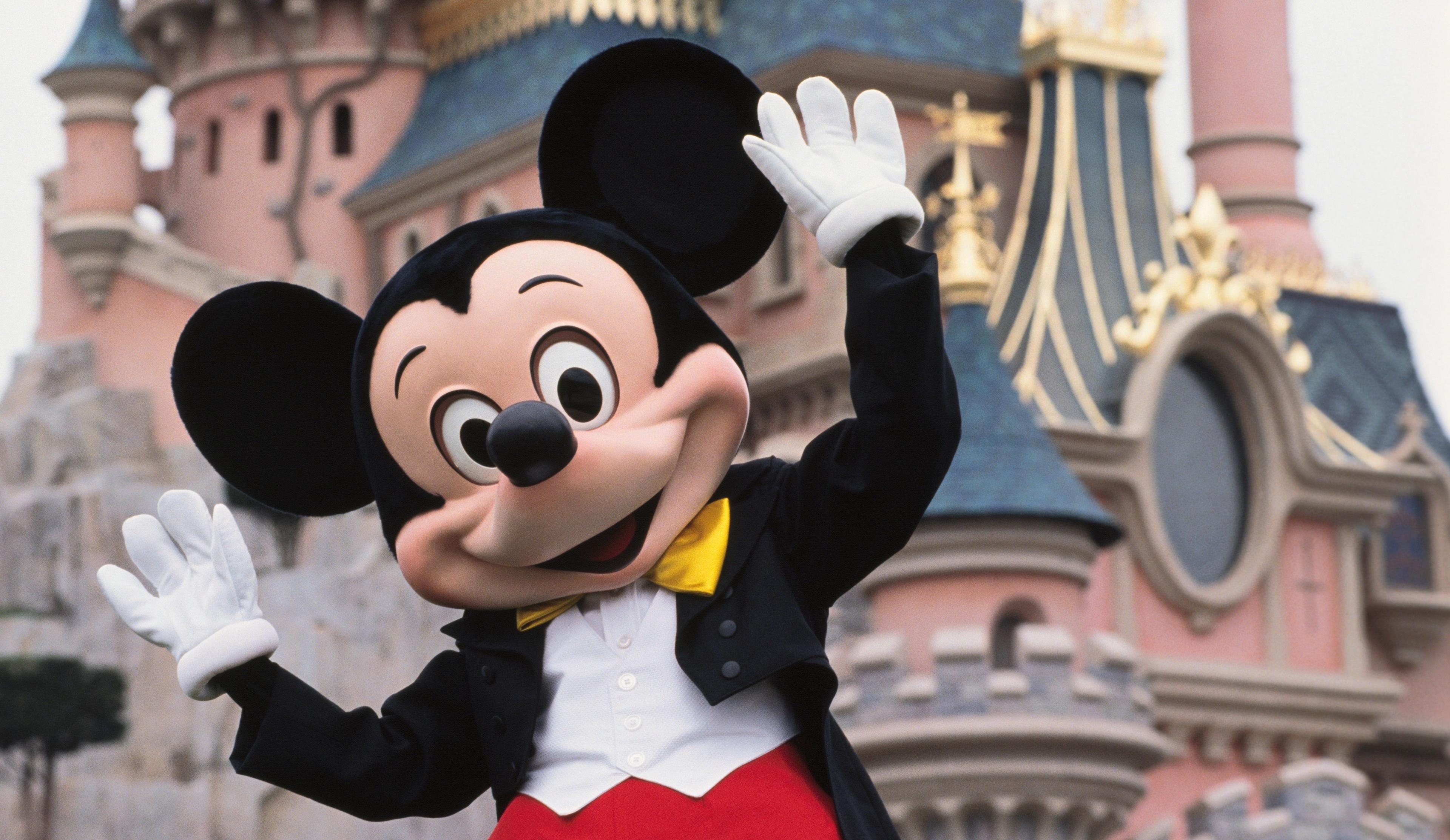 Mickey Mouse in front of the Sleeping Beauty Castle at Disneyland Resort Paris