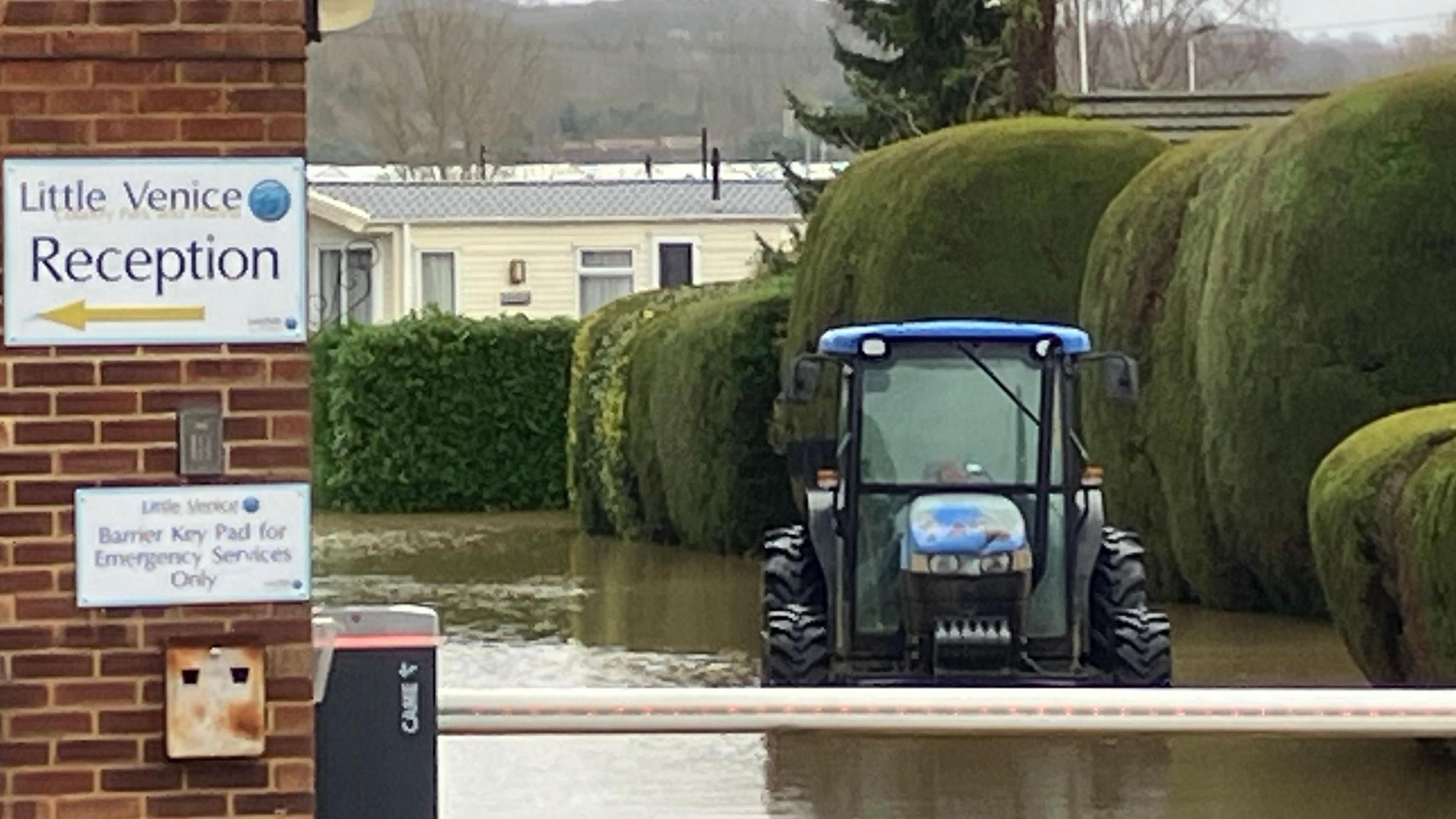 A blue tractor seen caught in a flooded area in the Little Venice Country Park area.