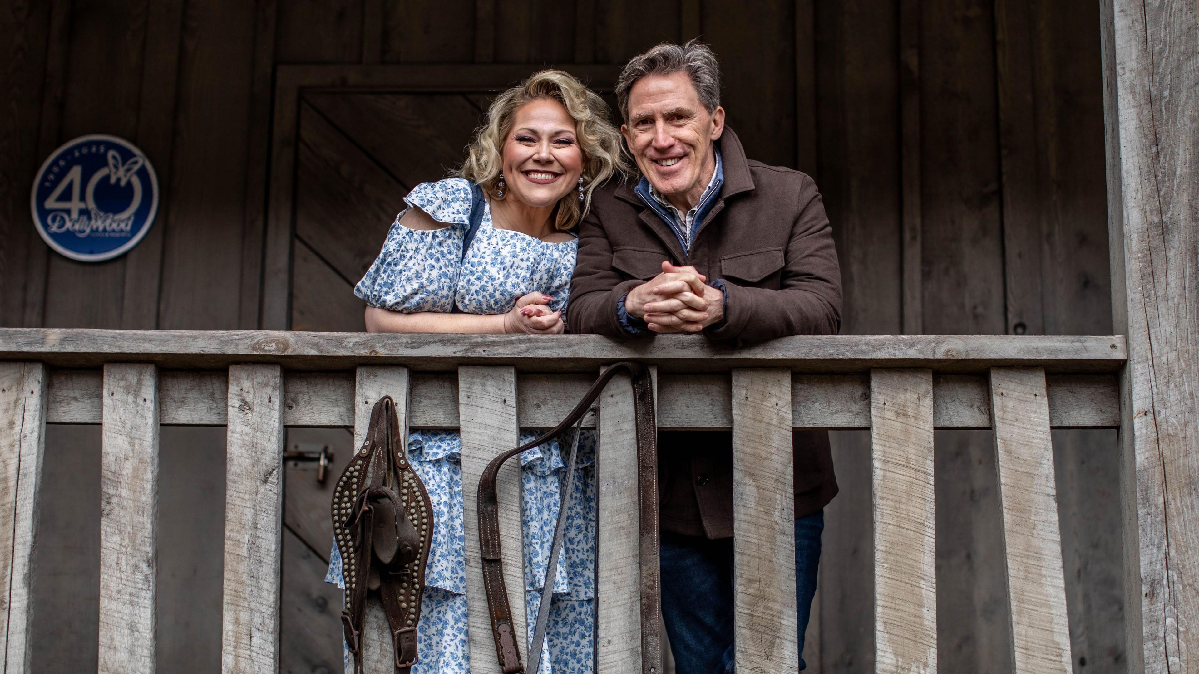 Rob Brydon and Dolly Partons niece Heidi Parton. They are standing on the porch of a remake of Dolly's childhood home